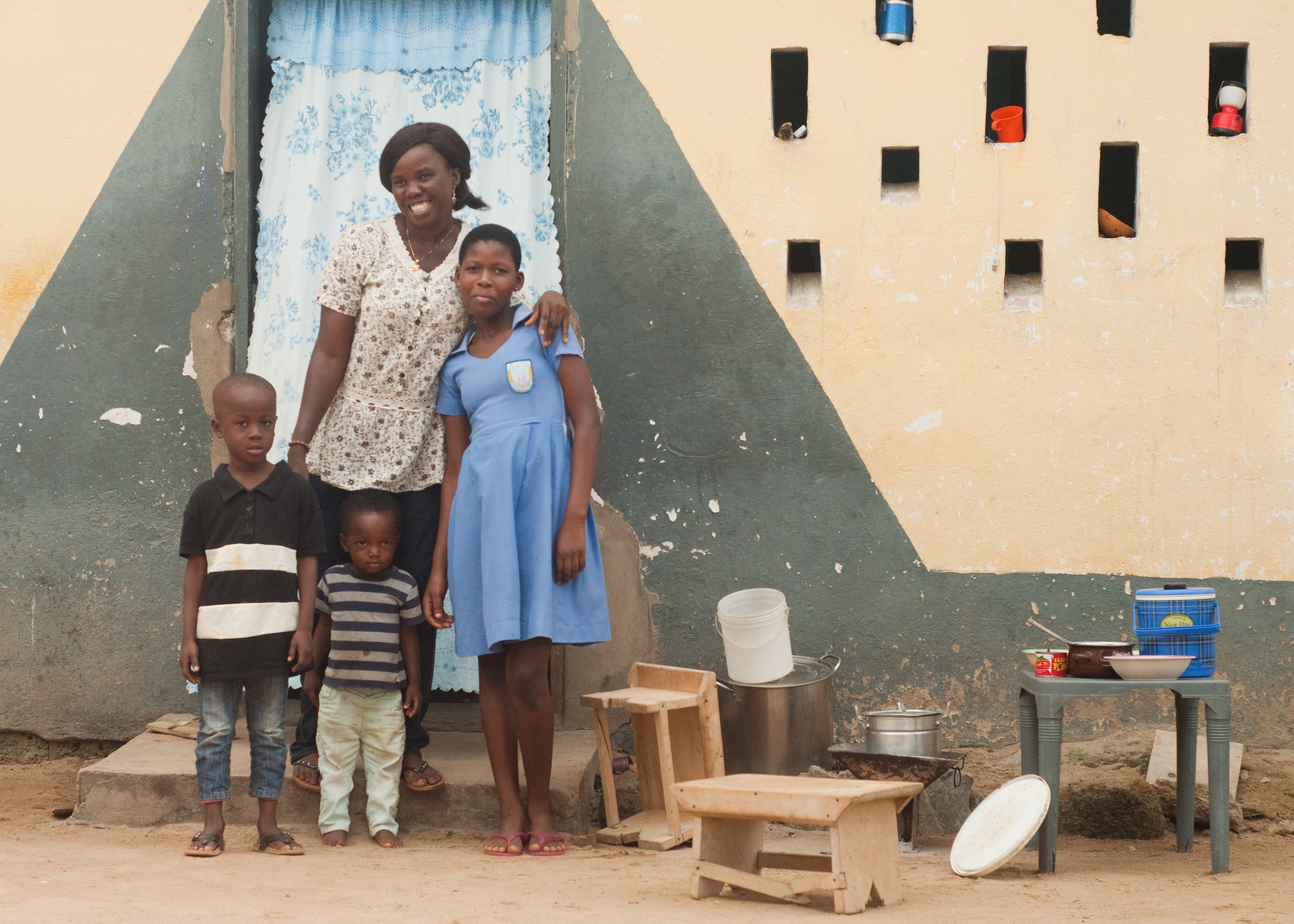 Rebecca and her children outside their home