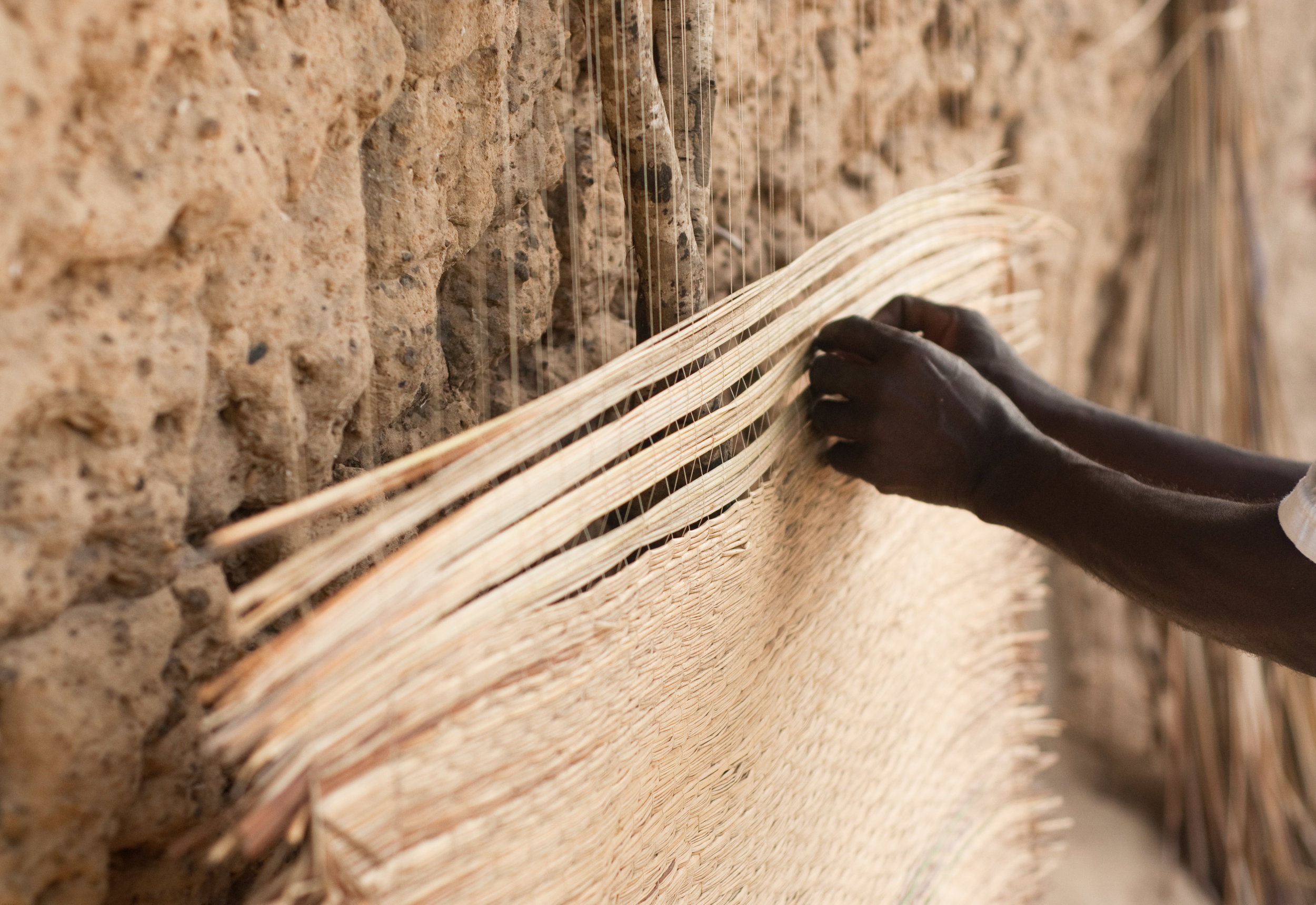Belinda's father weaving mats