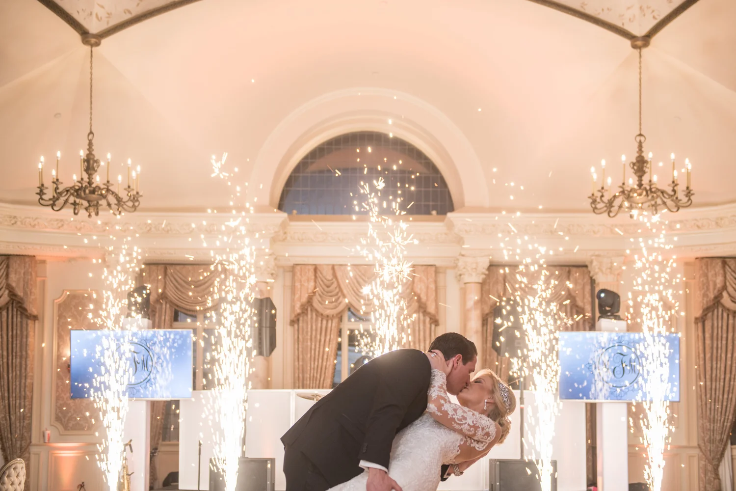 An E2 wedding couple sharing a kiss on the dance floor