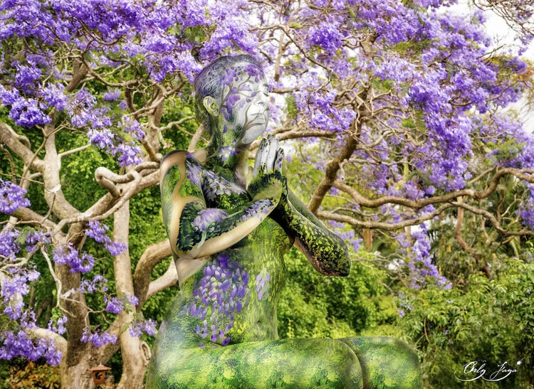 A meditating woman is "merged" into a flowering tree.
