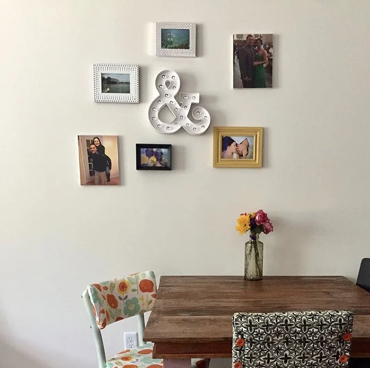 Our dining room table that seats four just perfectly was custom made by my brother. The top is made from old fence that at Matthew's parents house. Notice how few pictures were on the wall at the beginning.