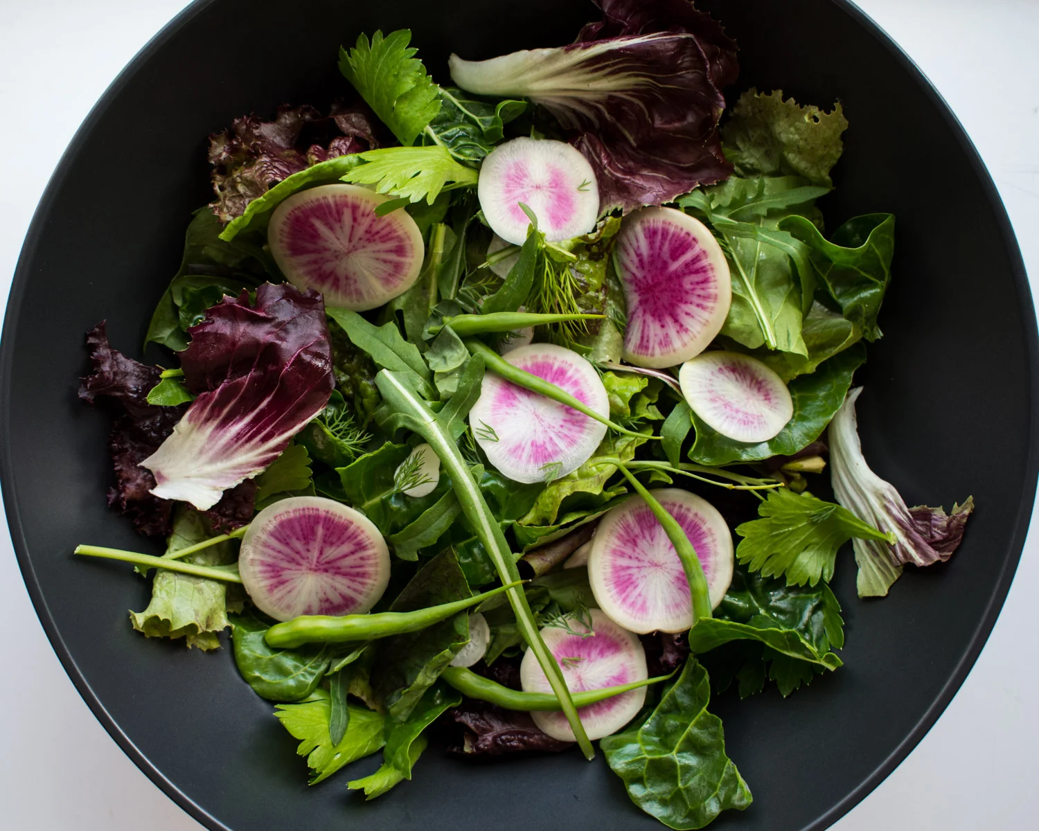 Fresh garden greens with 3 types of radish.