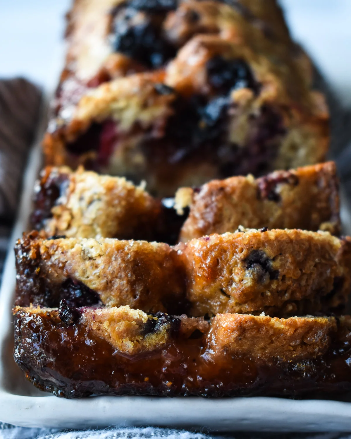 Slices of mixed fresh berry cake with homemade jam.