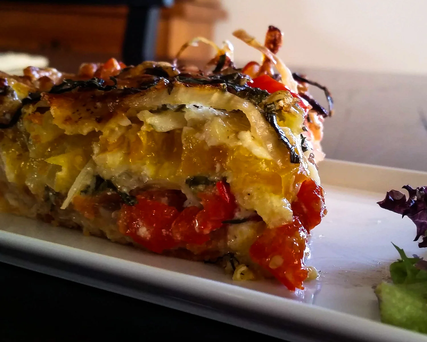 Layers of tomato, melted cheese and onion.