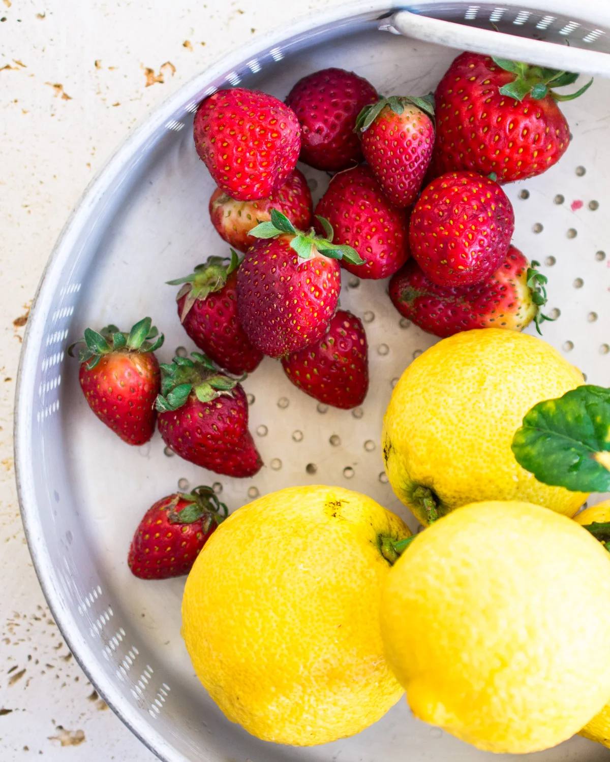Freshly garden gathered strawberries and lemons.