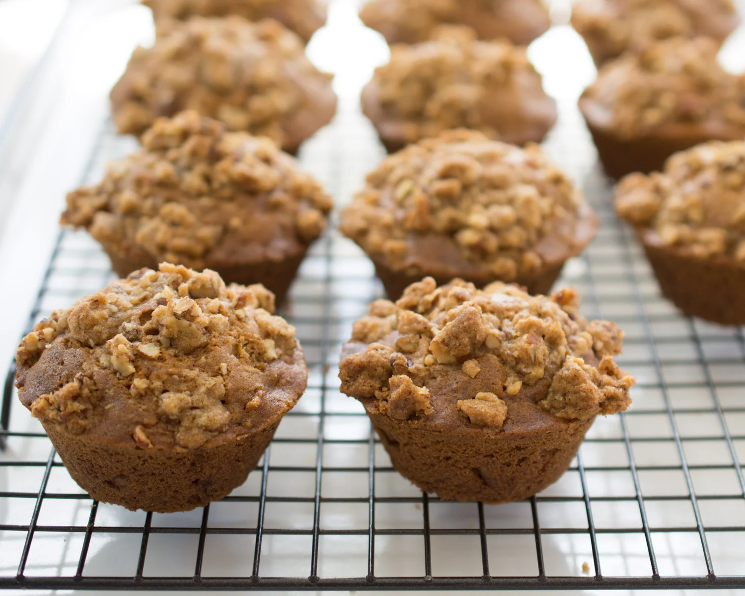 Carrot Cake Muffins cooling on the counter.