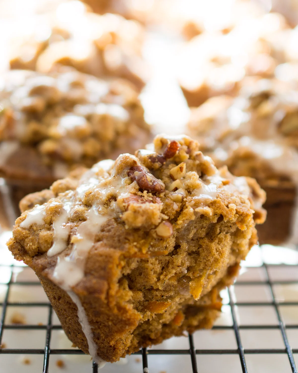 Carrot Cake Muffin topped with pecan streusel and lemon glaze. Ready to eat!