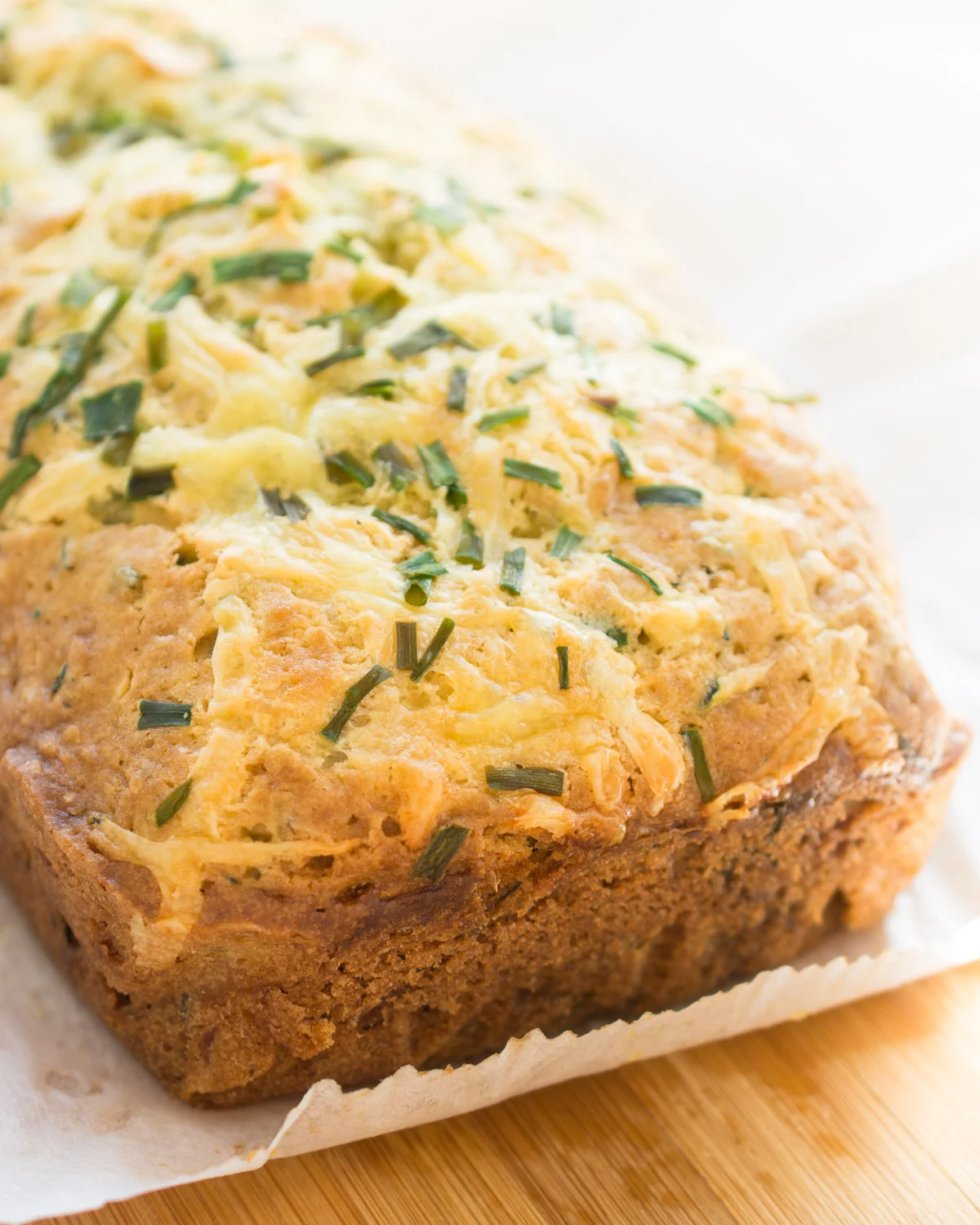 Cheesy Zucchini Bread with crunchy sides and top.