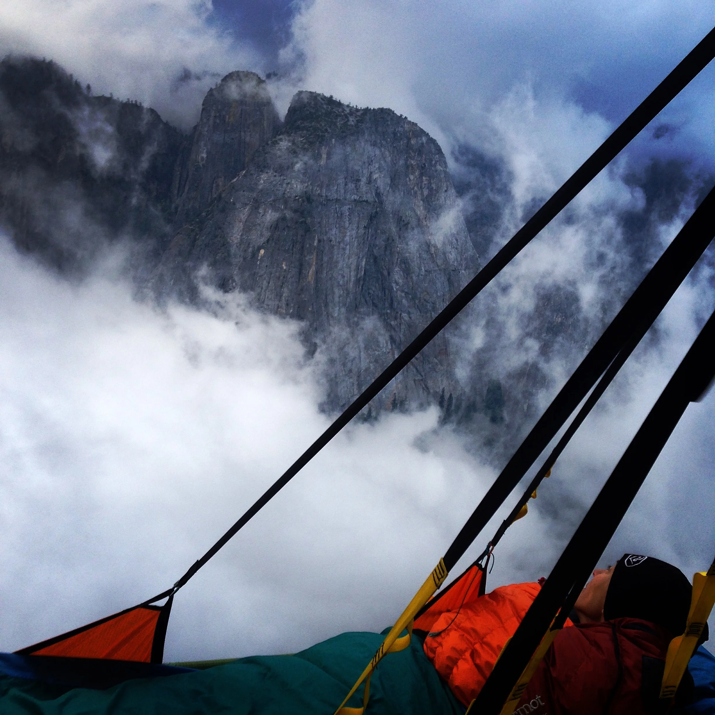 Eliza Kerr checks the weather on the third day of our ascent of the Zodiac, El Capitan, Yosemite.