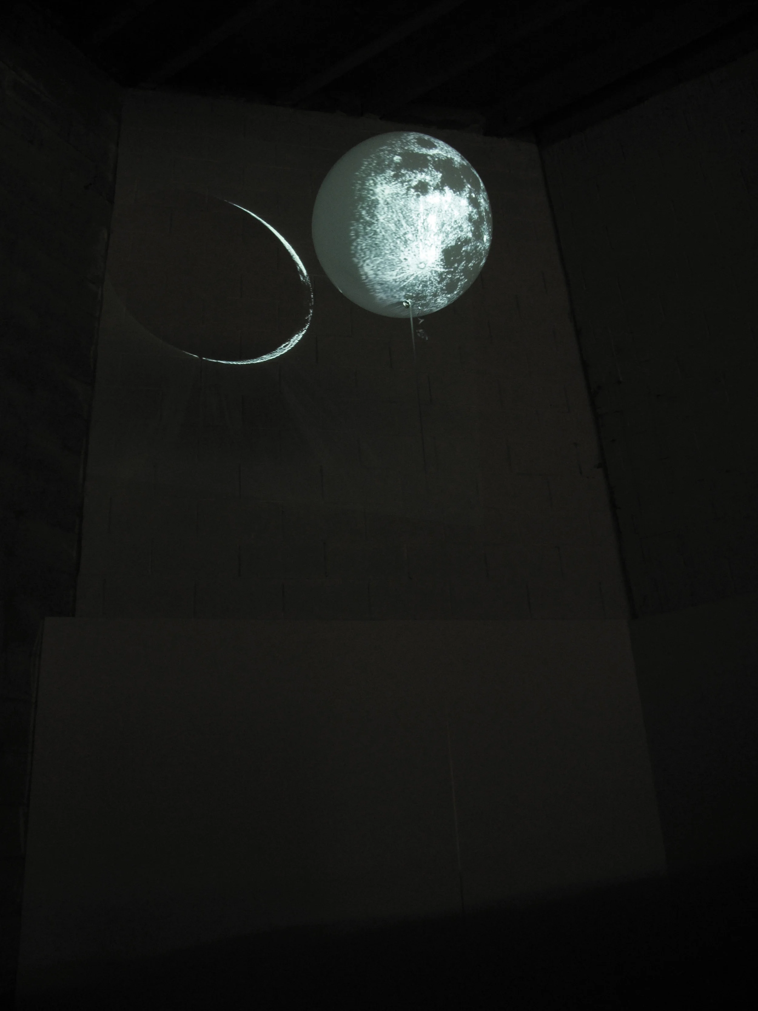 'Moon', Helium balloon, ribbon, rock and projection.