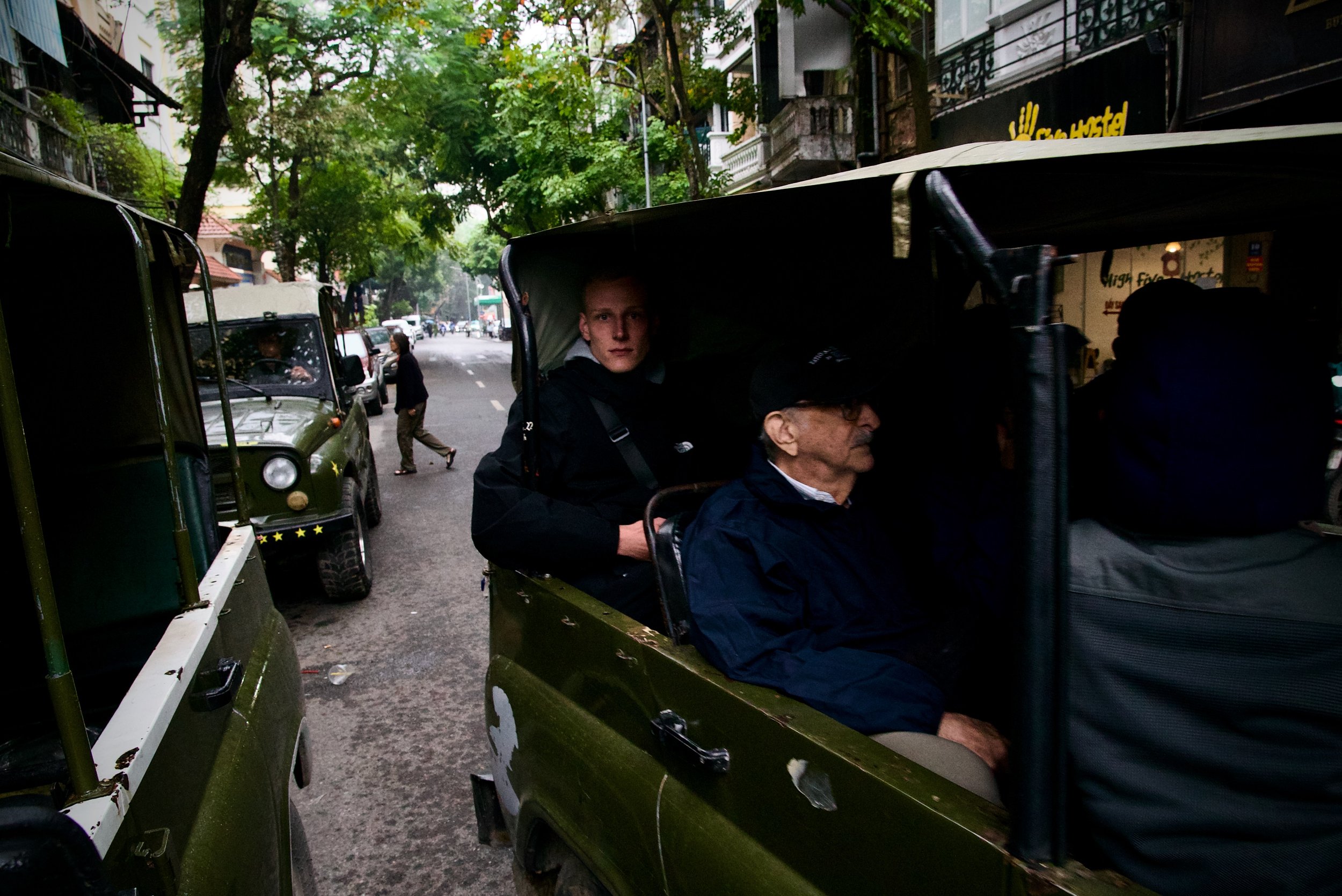 A tourist rides an old army jeep in Hanoi, Vietnam