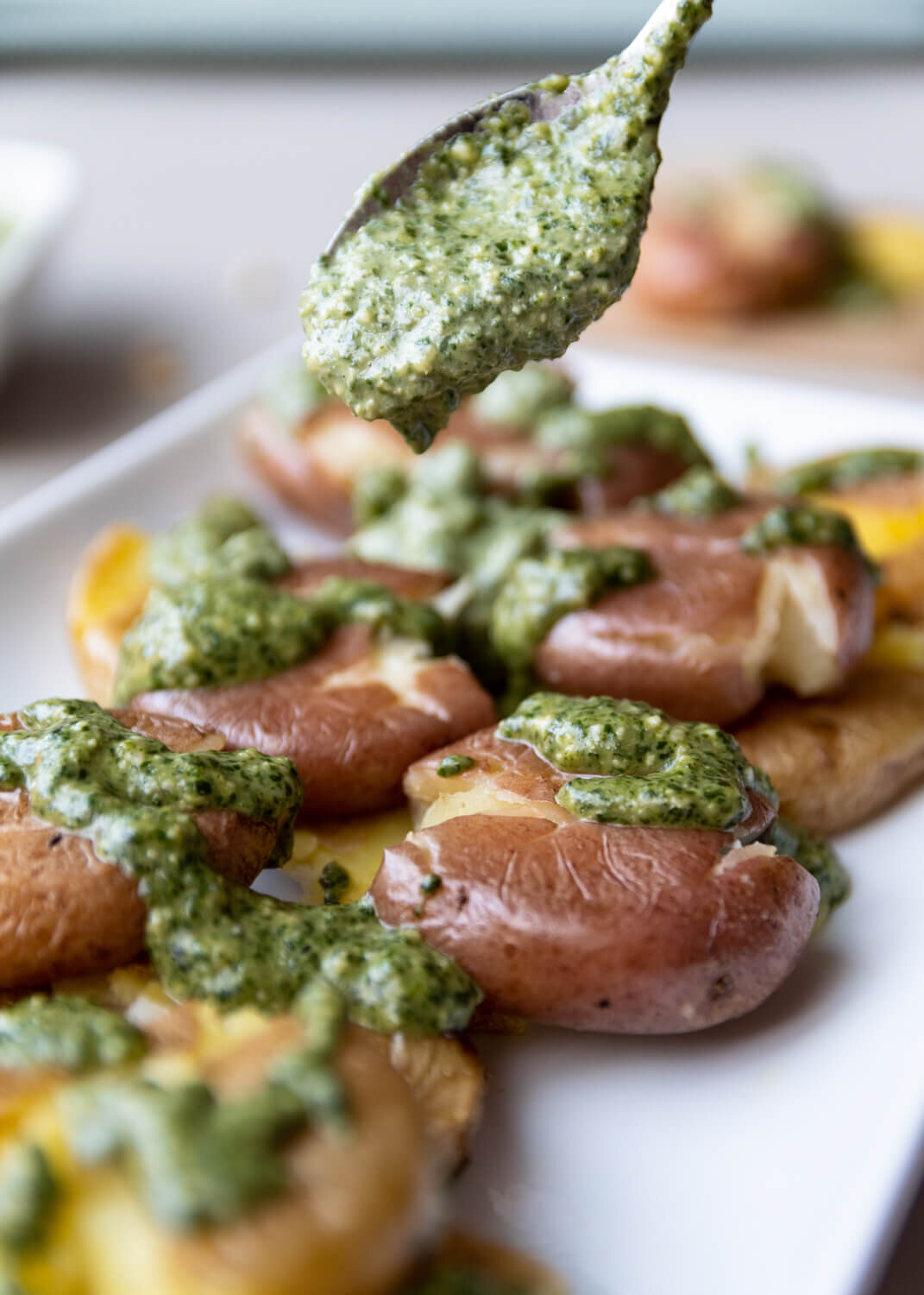 Vegan-Roasted-Smashed-Potatoes-with-Pesto-Drizzle-Green-Eatalia-crvnka-Photography.JPG