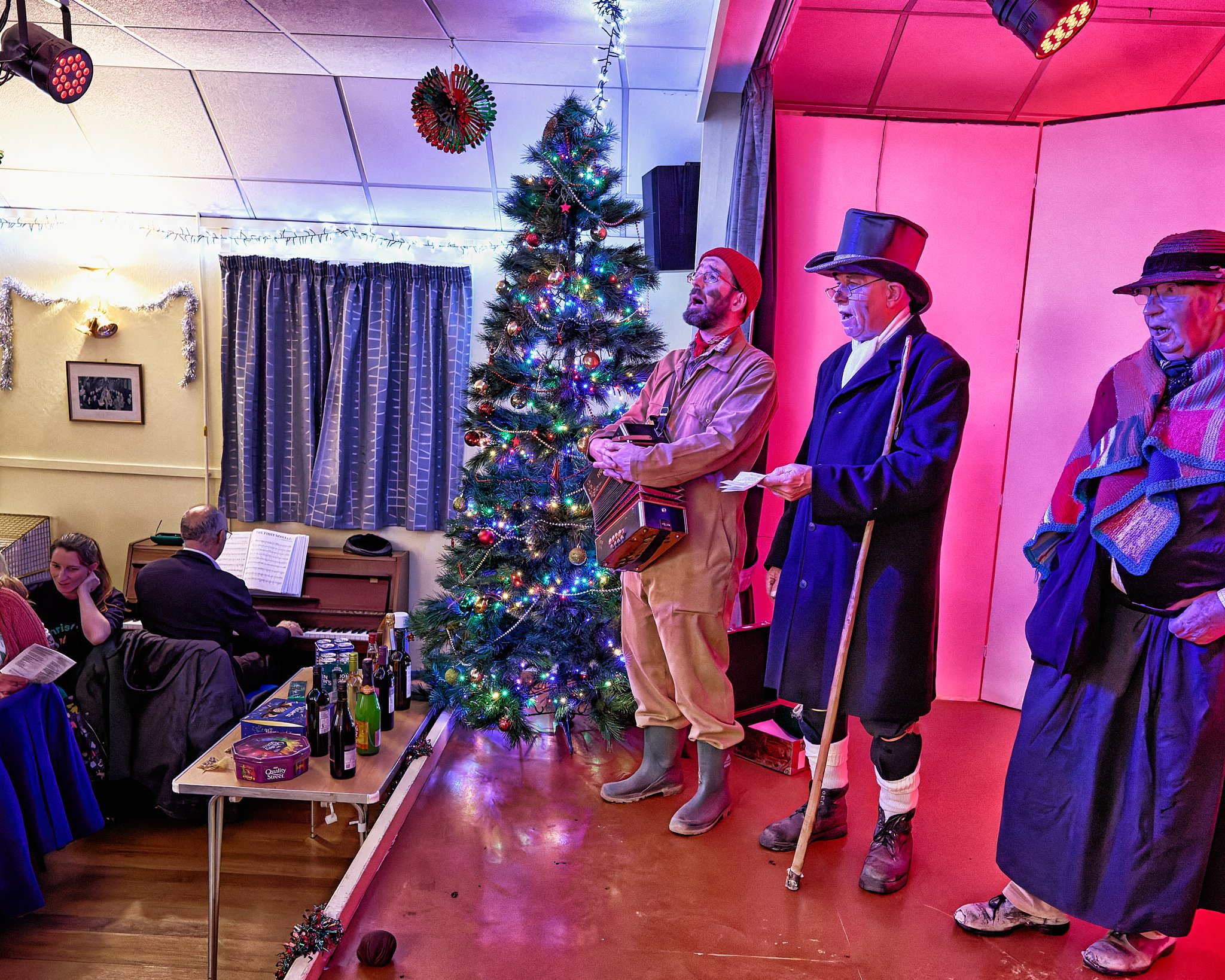 Documentary fieldwork photograph of The Hoodeners in Monkon Village Hall, showing musicians and audience participation