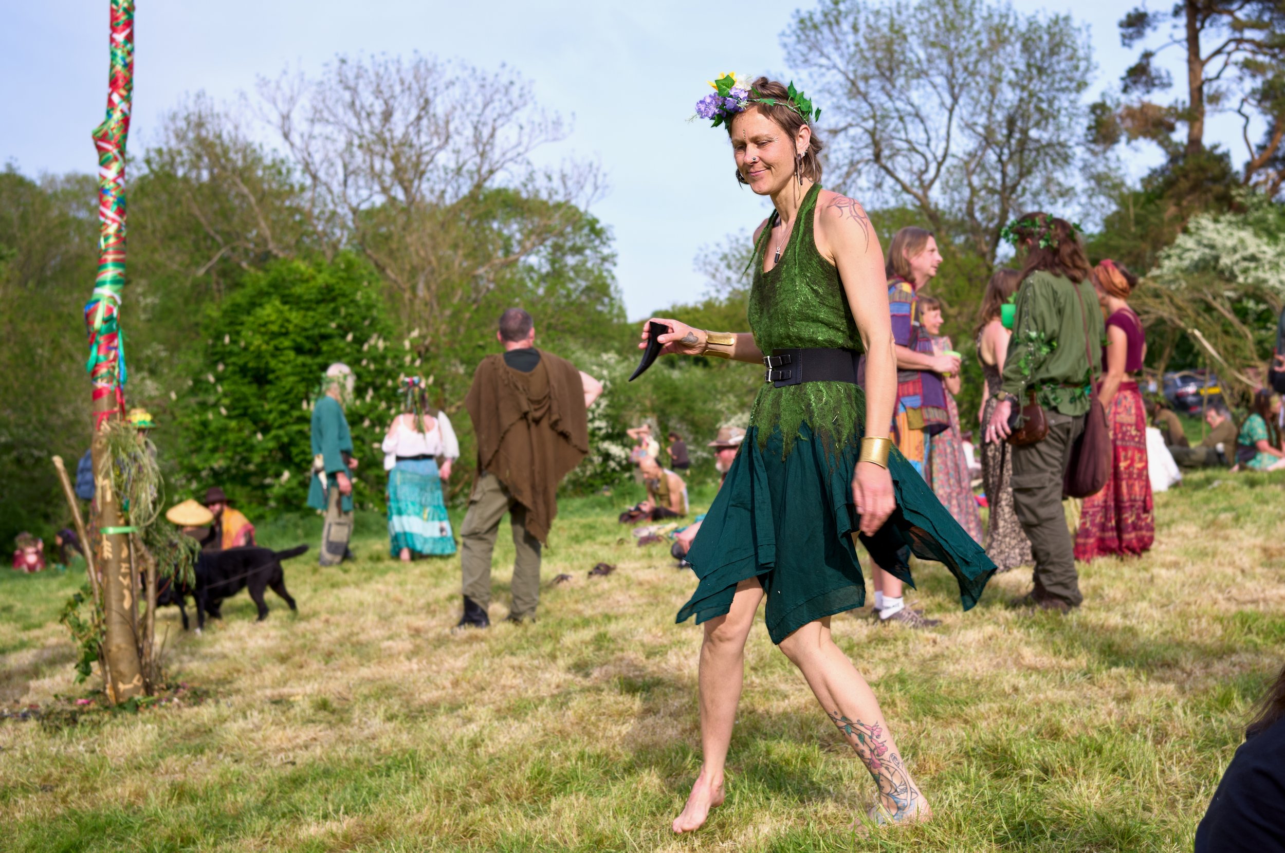 Documentary fieldwork photograph of Beltane in Glastonbury, showing joyful dancing with mead