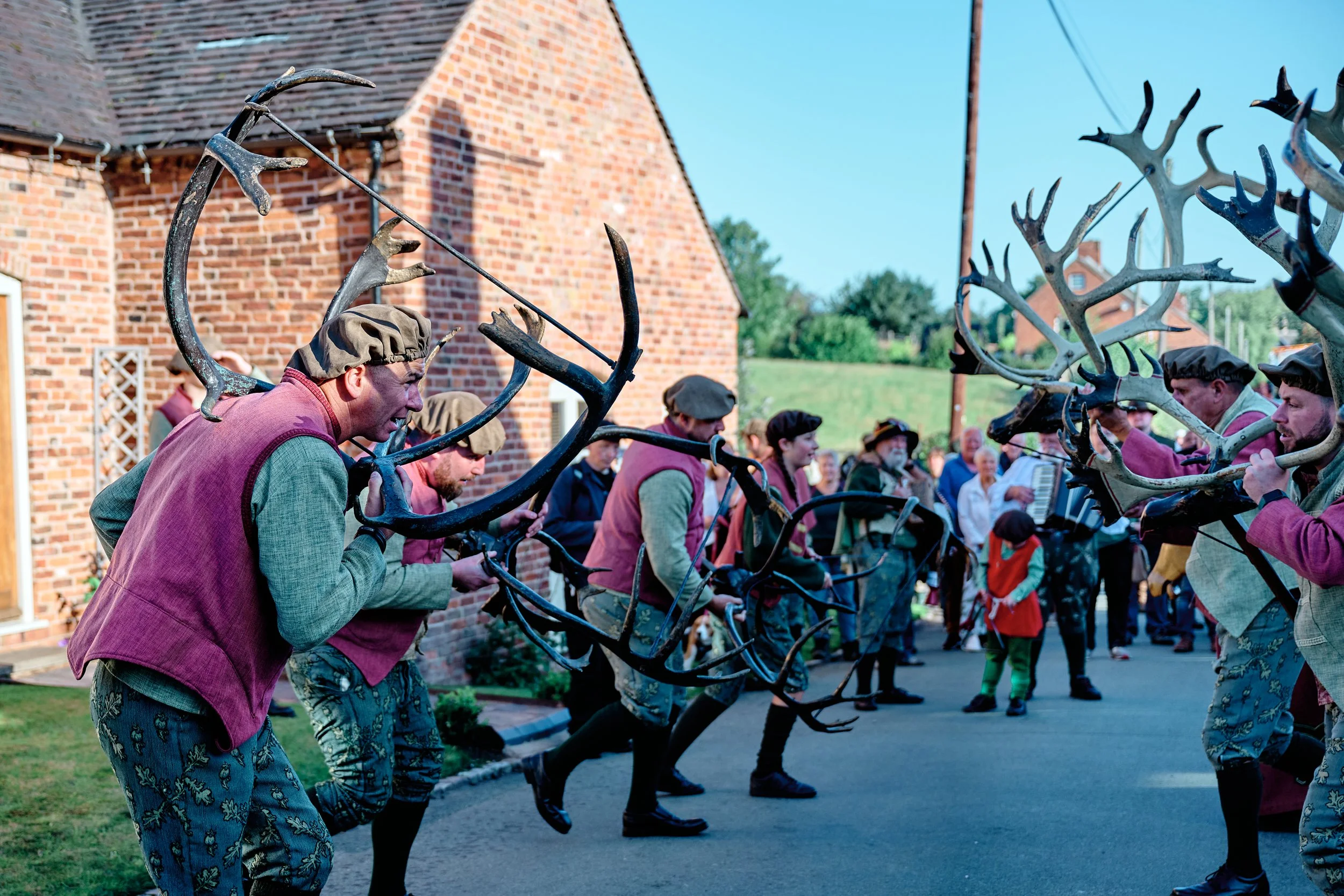 Documentary fieldwork photograph of the Horn Dance event in Abbots Bromley, showing the horn dancers in action