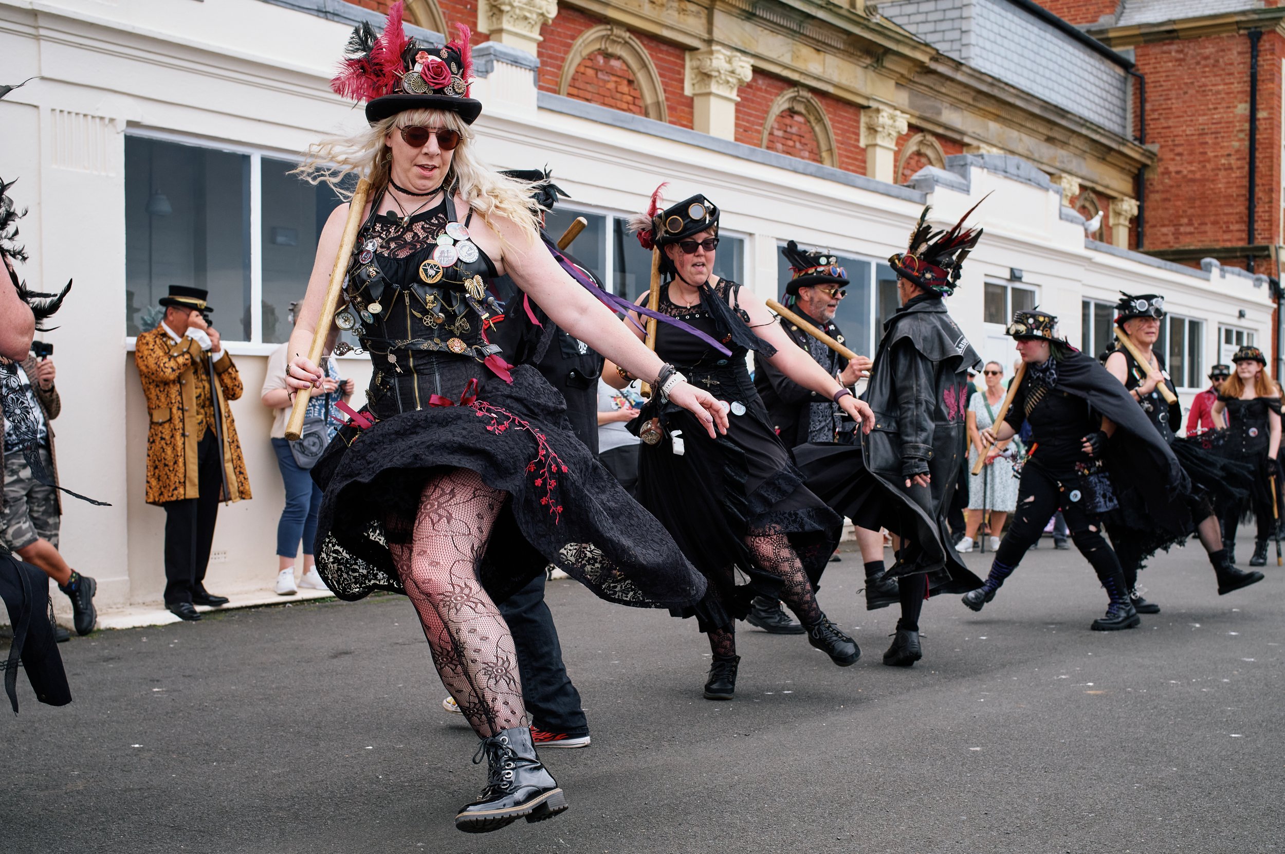 Documentary fieldwork photograph of Steampunk participants in Gothic Whitby, showing The Ravens Morris street theatre