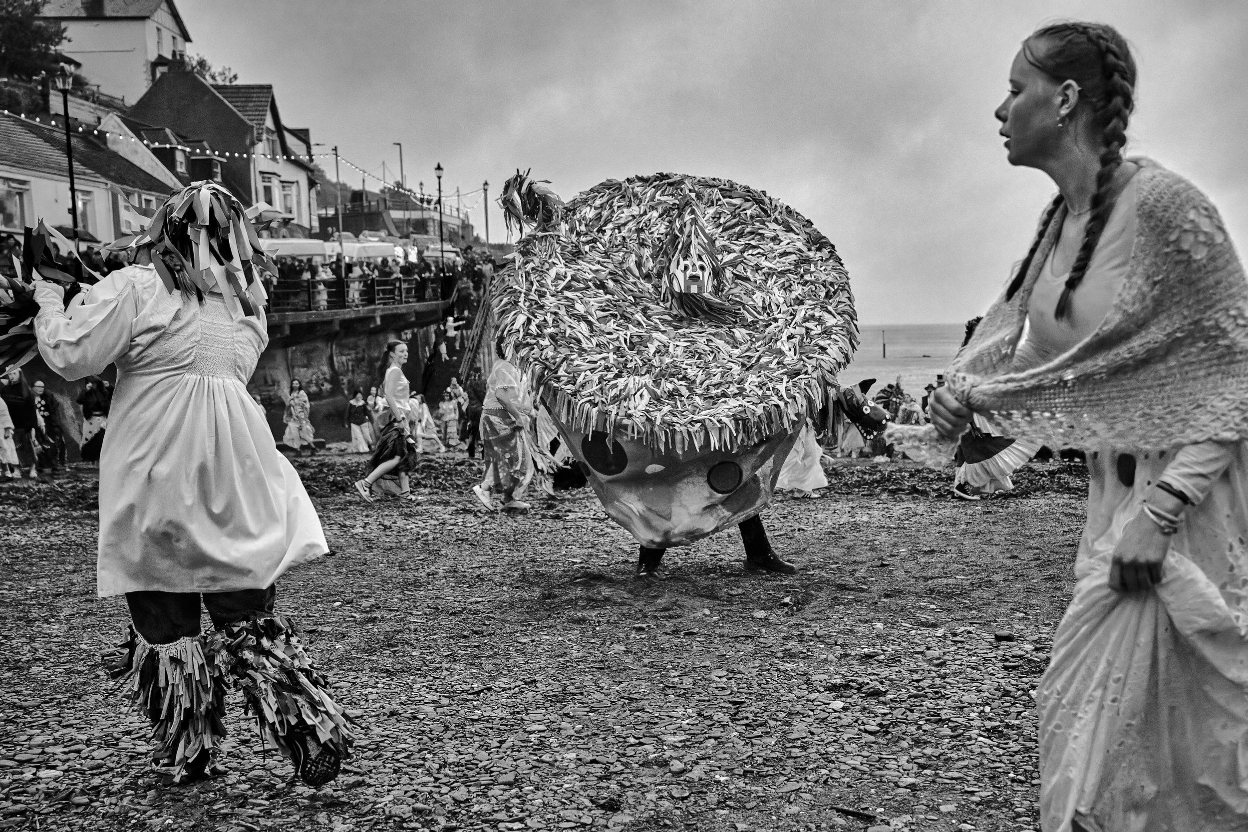 Documentary fieldwork photograph of Hunting the Earl of Rone in Coombe Martin, showing the Wickerman Style beach dancing after sunset