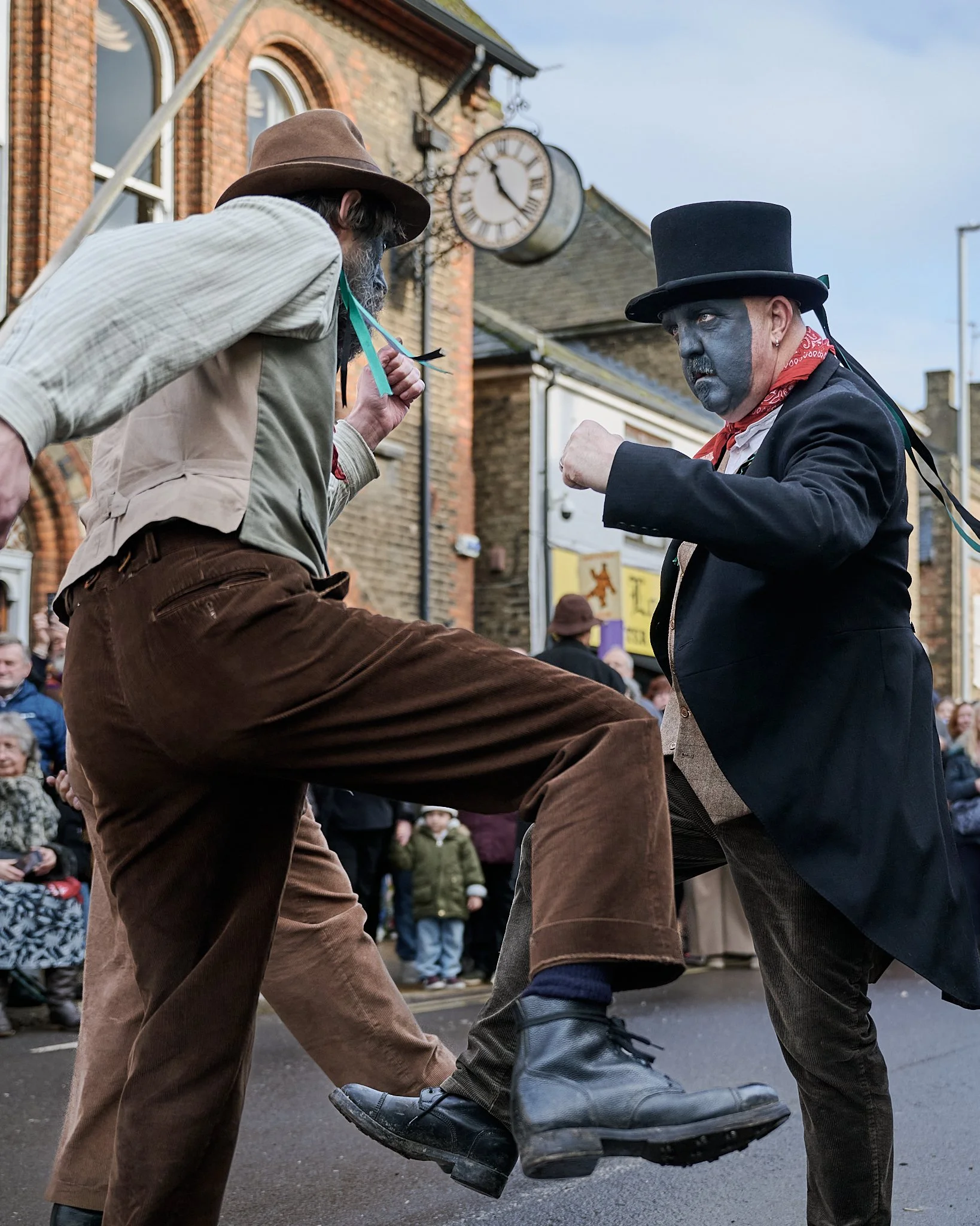 Documentary fieldwork photograph of Old Glory Morris in Whittlesey, showing their unique guising face paint and molly dancing style