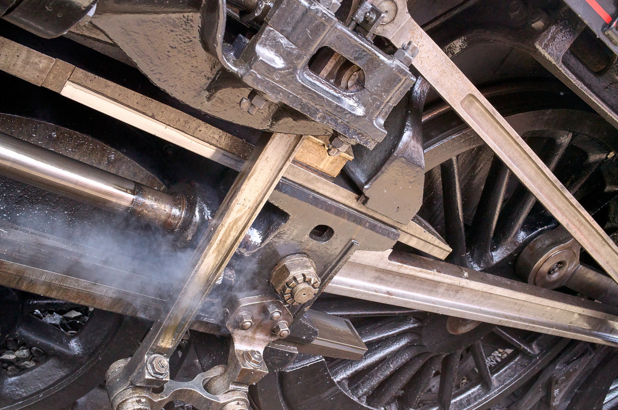 Documentary fieldwork photograph of Steampunk participants in Gothic Whitby, showing the engineering of Steam Locomotive 5428