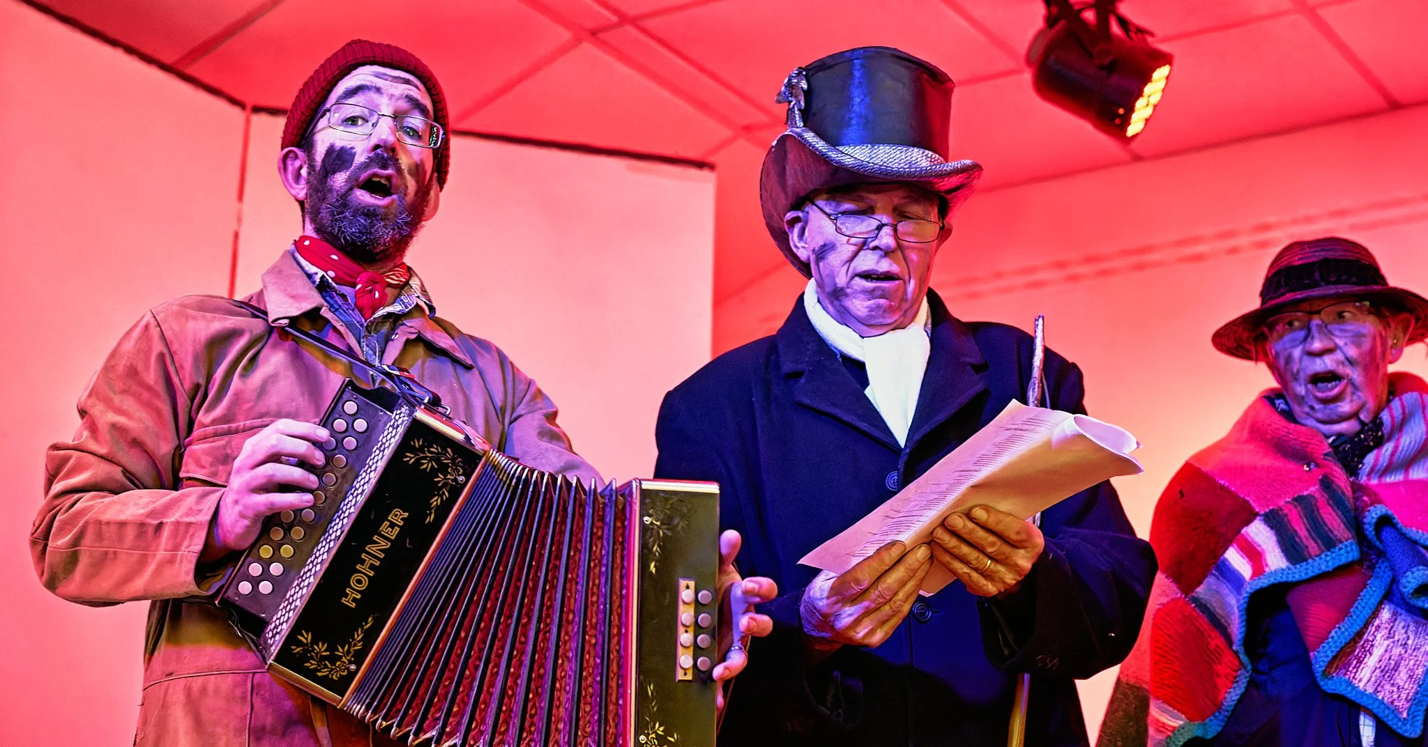 Documentary fieldwork photograph of The Hoodeners in Monkon Village Hall, showing musicians leading the singalong