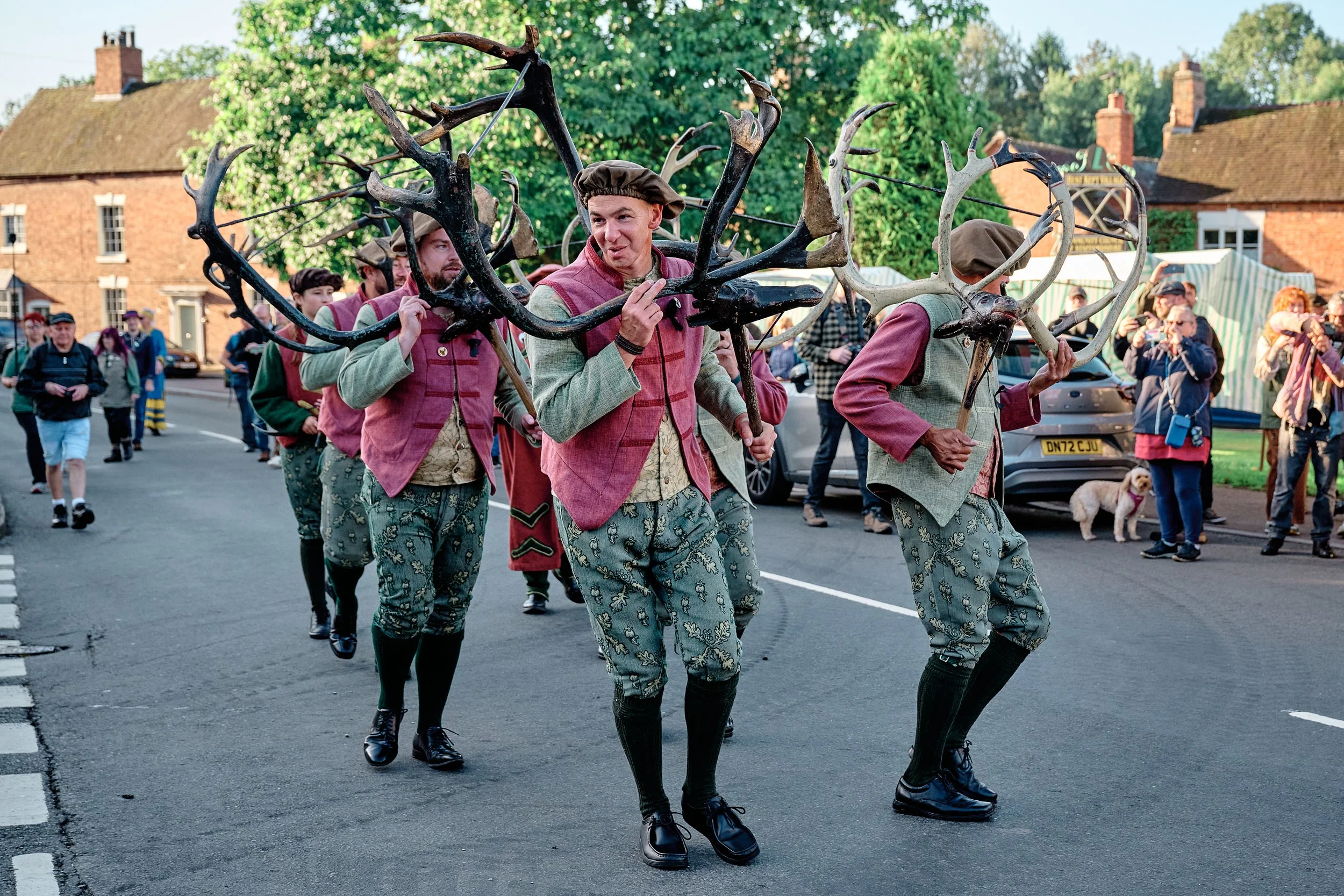 Documentary fieldwork photograph of the Horn Dance event in Abbots Bromley, showing dancers engaging in conversation with the crowd
