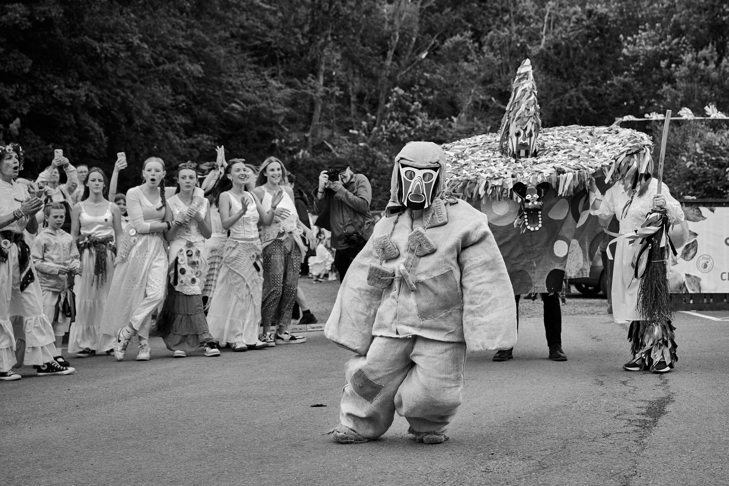 Documentary fieldwork photograph of Hunting the Earl of Rone in Coombe Martin, showing The Earl of Rone shot with Hobby Horse and Fool looking on