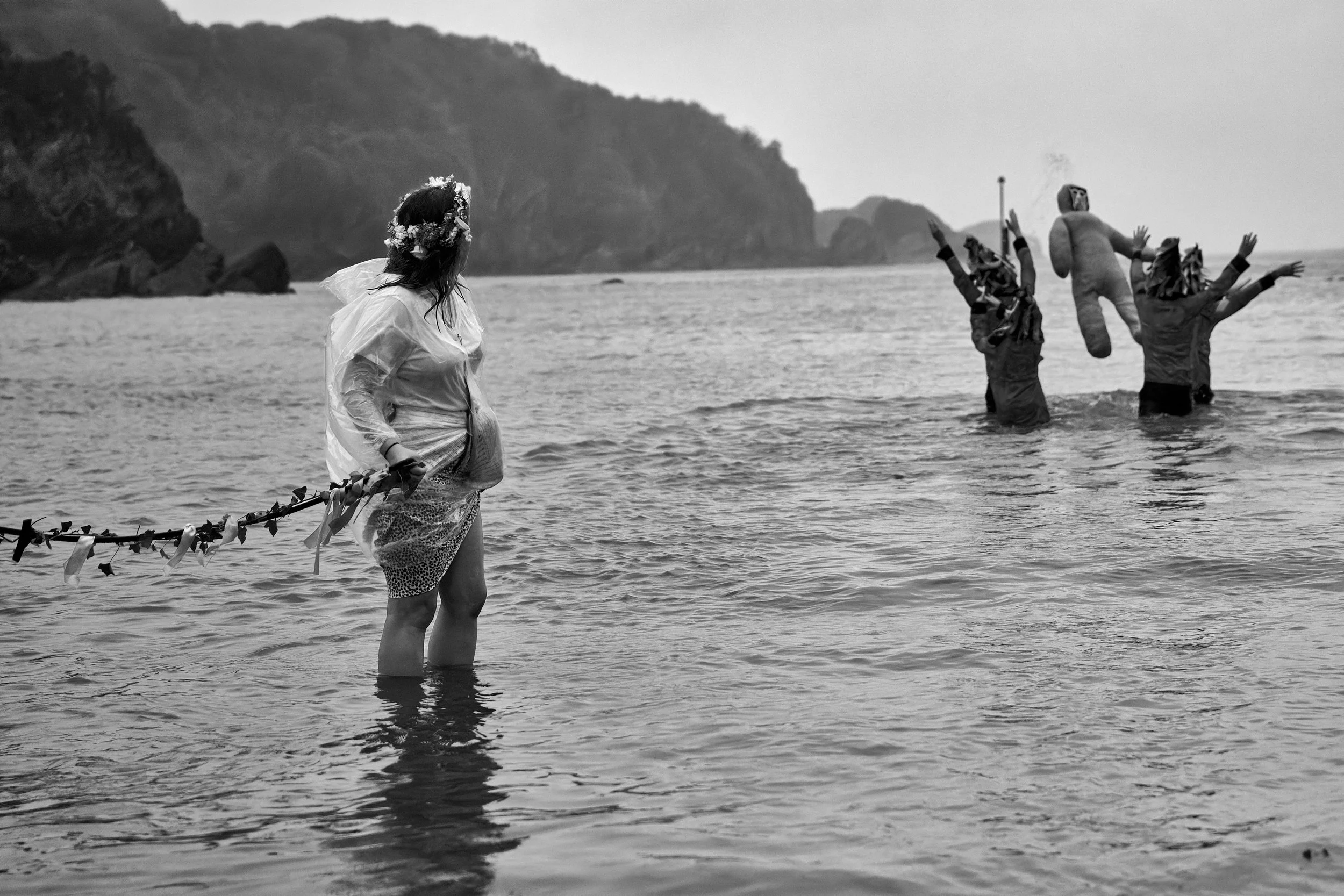 Documentary fieldwork photograph of Hunting the Earl of Rone in Coombe Martin, showing the Earl of Rone effigy cast into the sea to drown