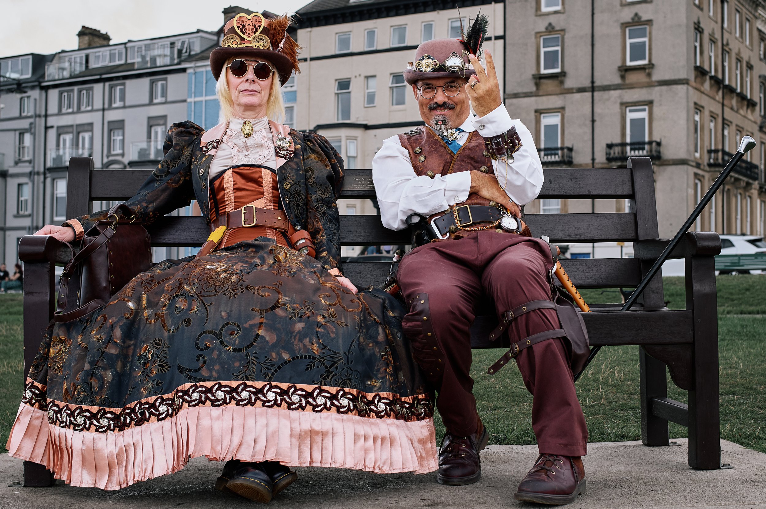 Documentary fieldwork photograph of Steampunk participants in Gothic Whitby, demonstrating confident Victorian culture in two fingers salute