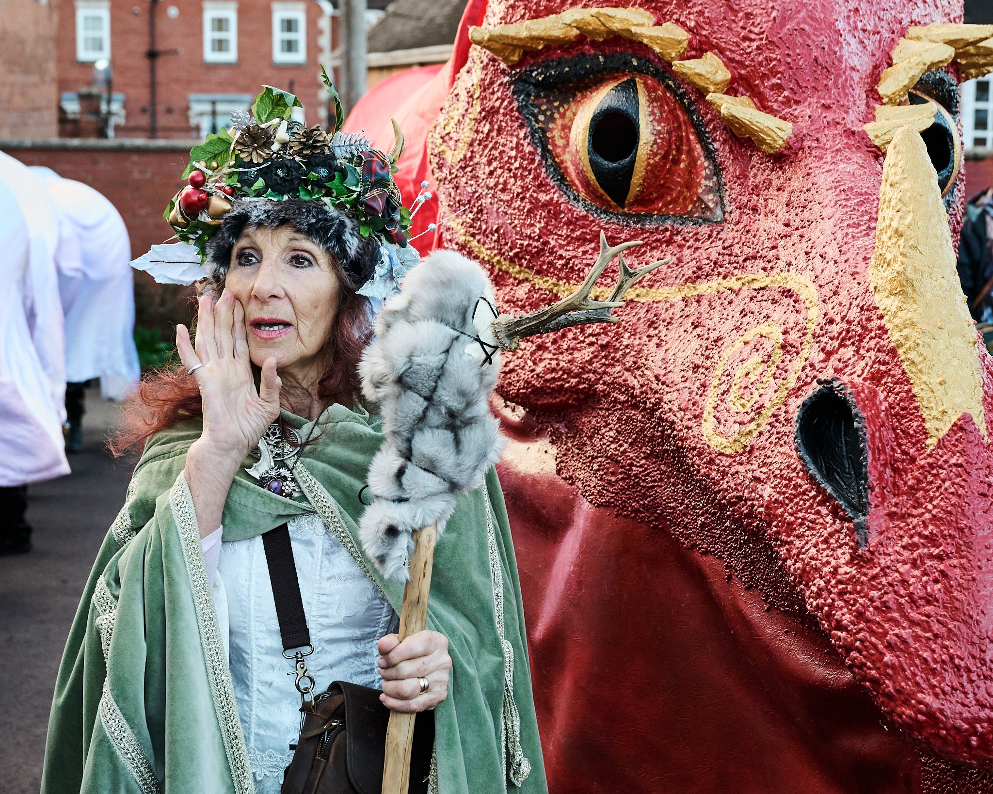 Documentary fieldwork photograph of Celtic Samhain Wild Hunt in Glastonbury, showing the Red Dragon's handler in a call to arms