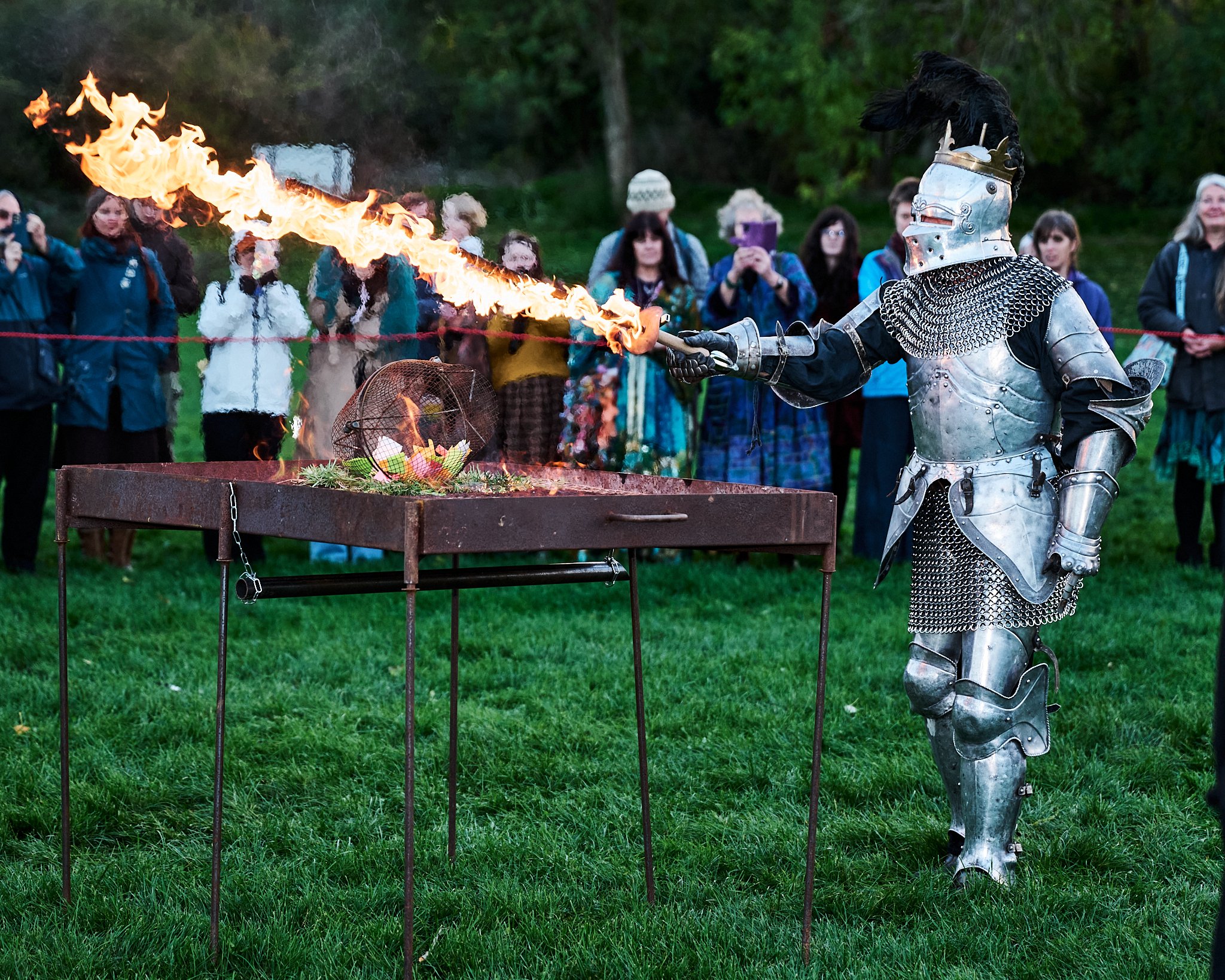 Documentary fieldwork photograph of Celtic Samhain Wild Hunt in Glastonbury, showing mythical King Arthur with flaming sword