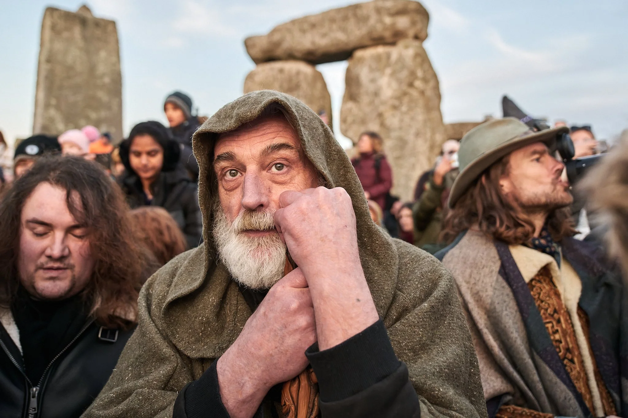 Documentary fieldwork photograph of a Druid inside Stonehenge Stone Circle, showing his contemplation at the Spring Equinox sunrise