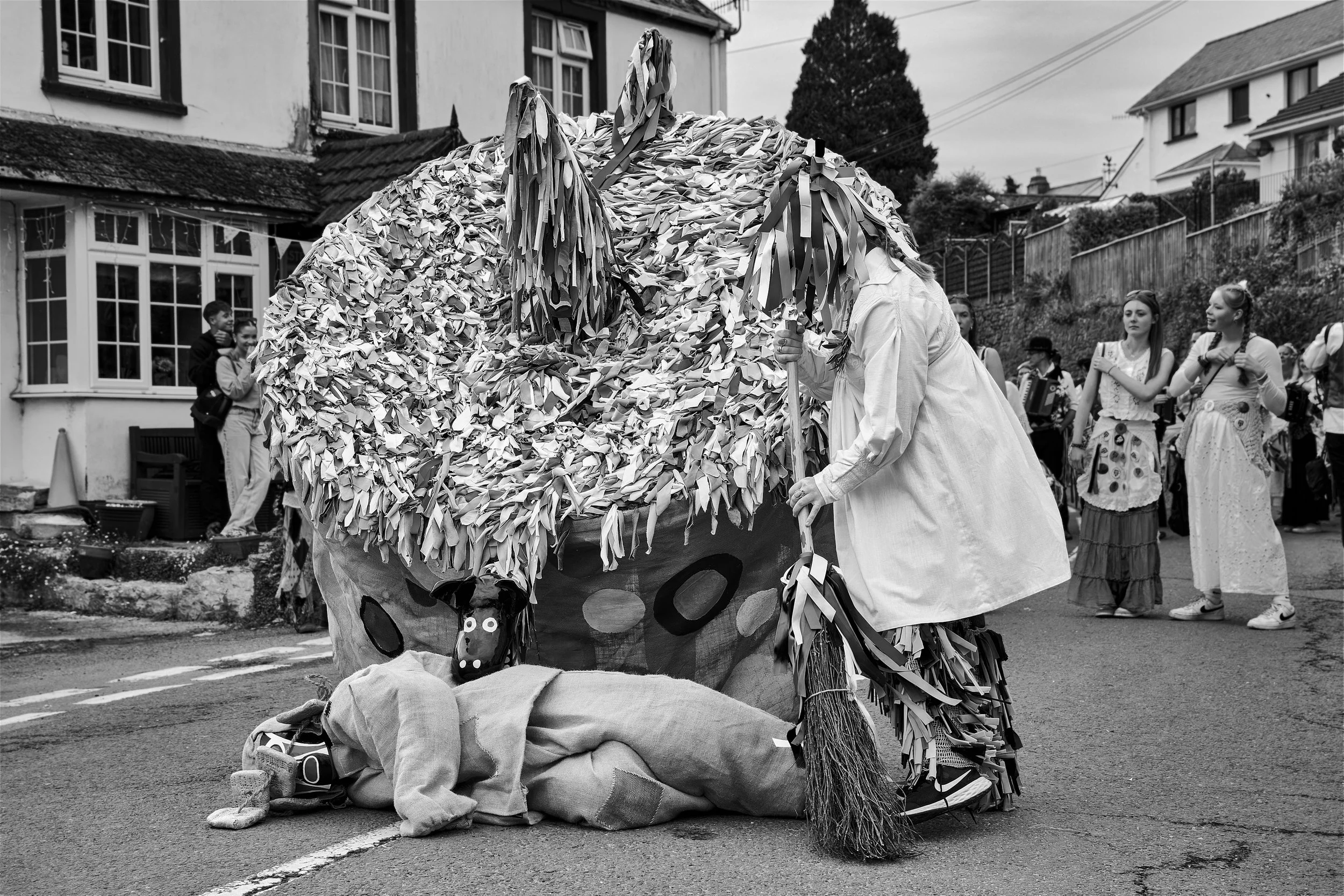 Documentary fieldwork photograph of Hunting the Earl of Rone in Coombe Martin, showing the resurrection of the fallen Earl by the Hobby Horse