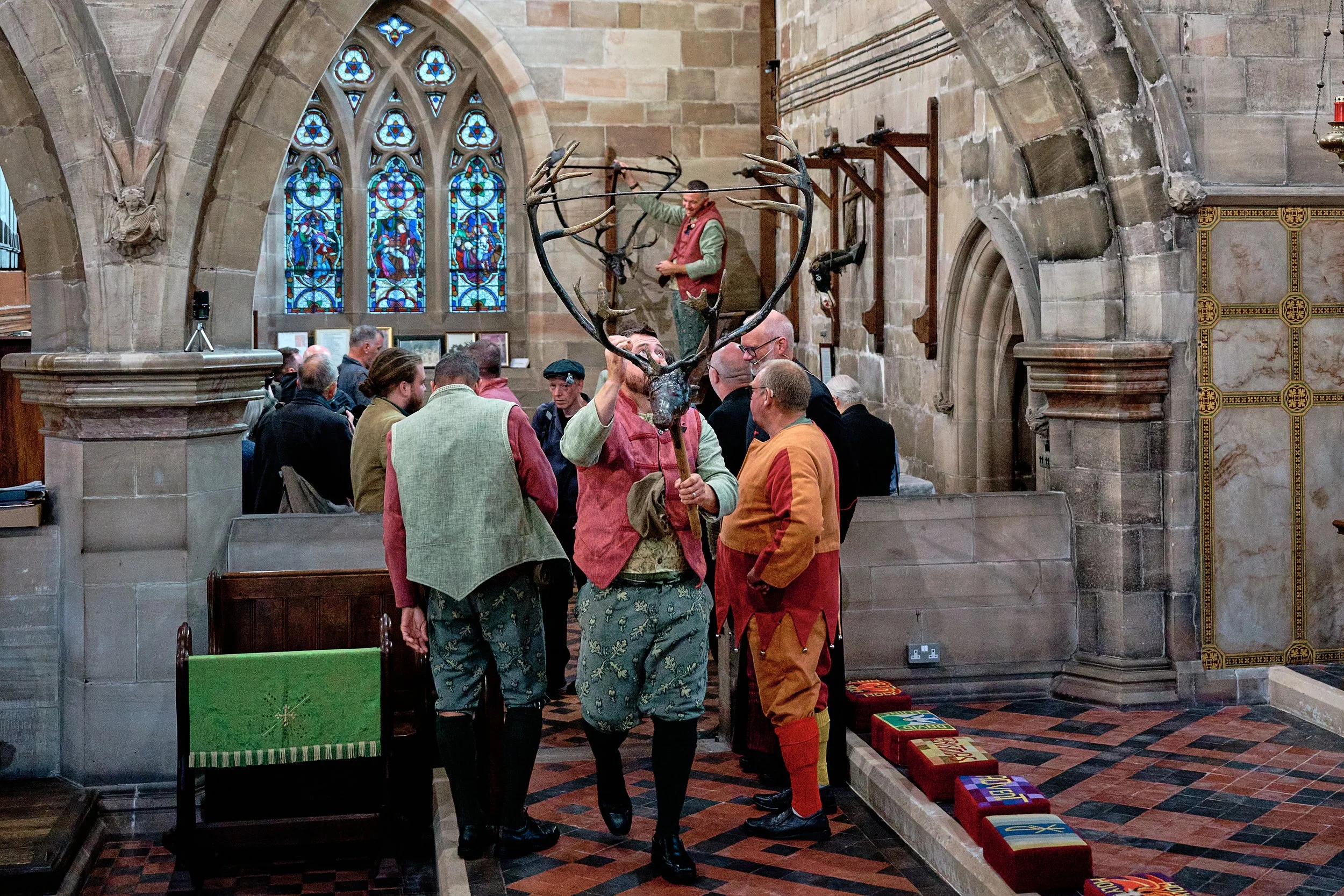 Documentary fieldwork photograph of the Horn Dance event in St Nicholas Church, Abbots Bromley, showing taking down the 1000 years old antlers for blessing