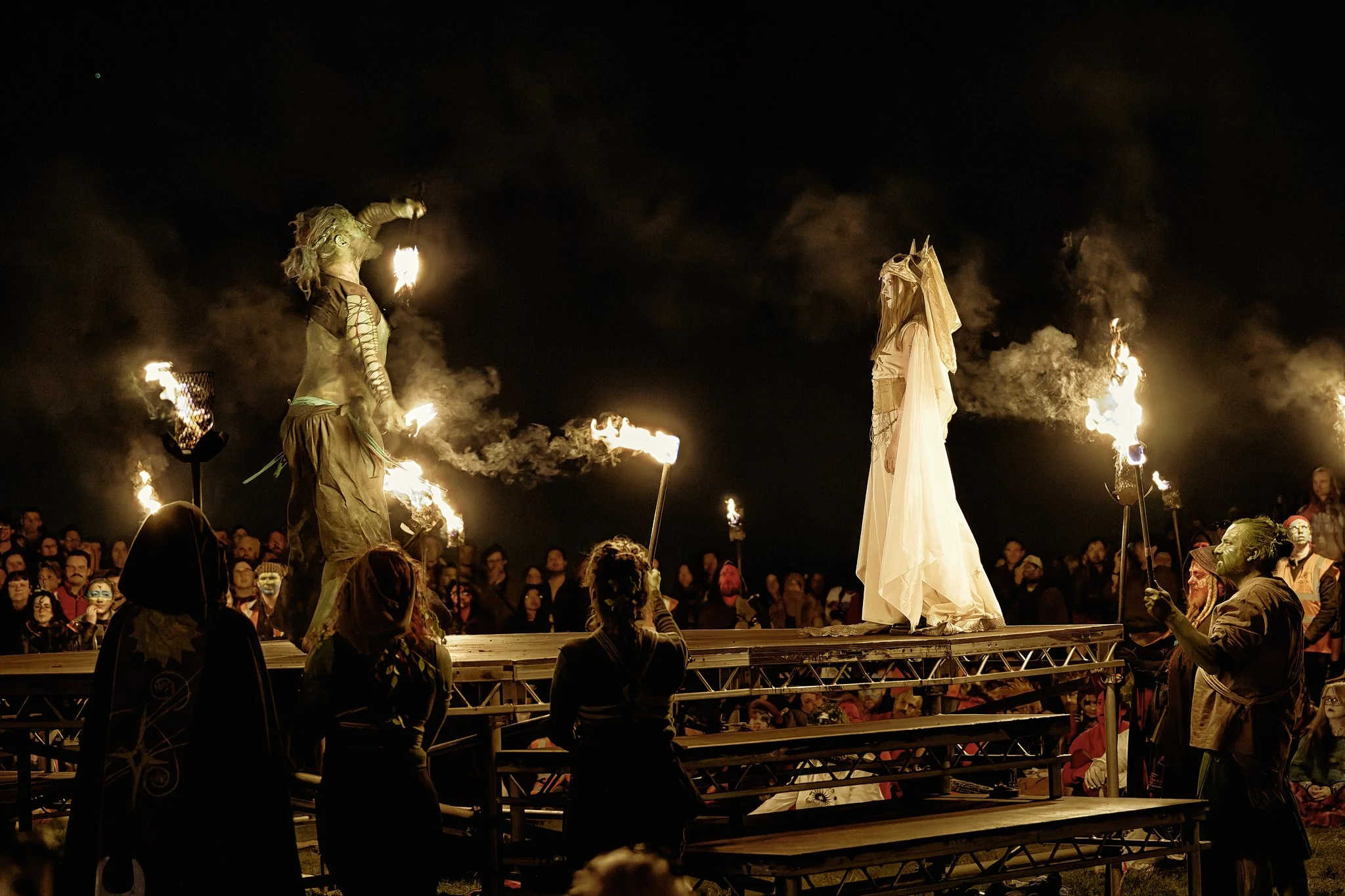 This documentary fieldwork photograph shows the Summer Green Man winning over the May Queen with vigorous fire juggling. Beltane, Edinburgh 2026