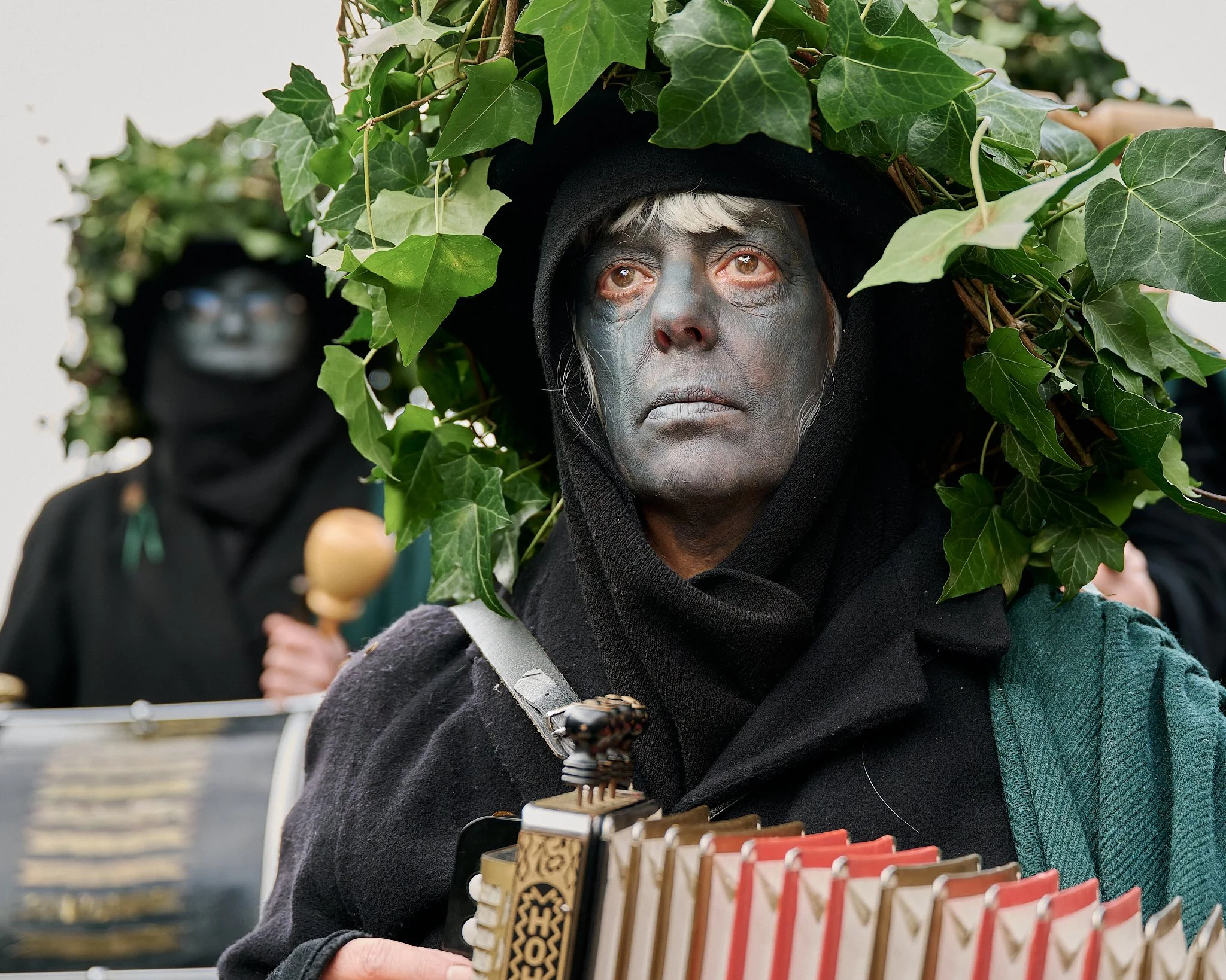 Documentary fieldwork photograph of Old Glory Morris musician in Whittlesey, showing their costume and blank stare