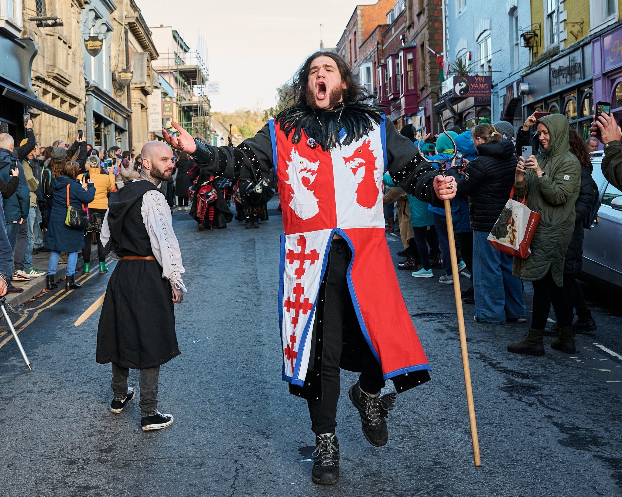 Documentary fieldwork photograph of Celtic Samhain Wild Hunt in Glastonbury, showing the Glastonbury Dragons Herald leding the parade