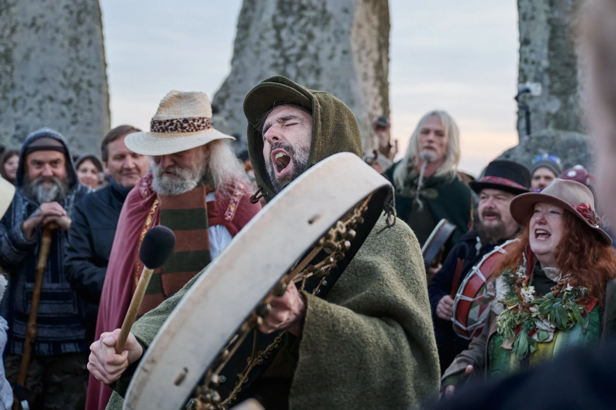 Documentary fieldwork photograph of a Druid Green Man in the Stonehenge Stone Circle, showing celebratory song at the Spring Equinox