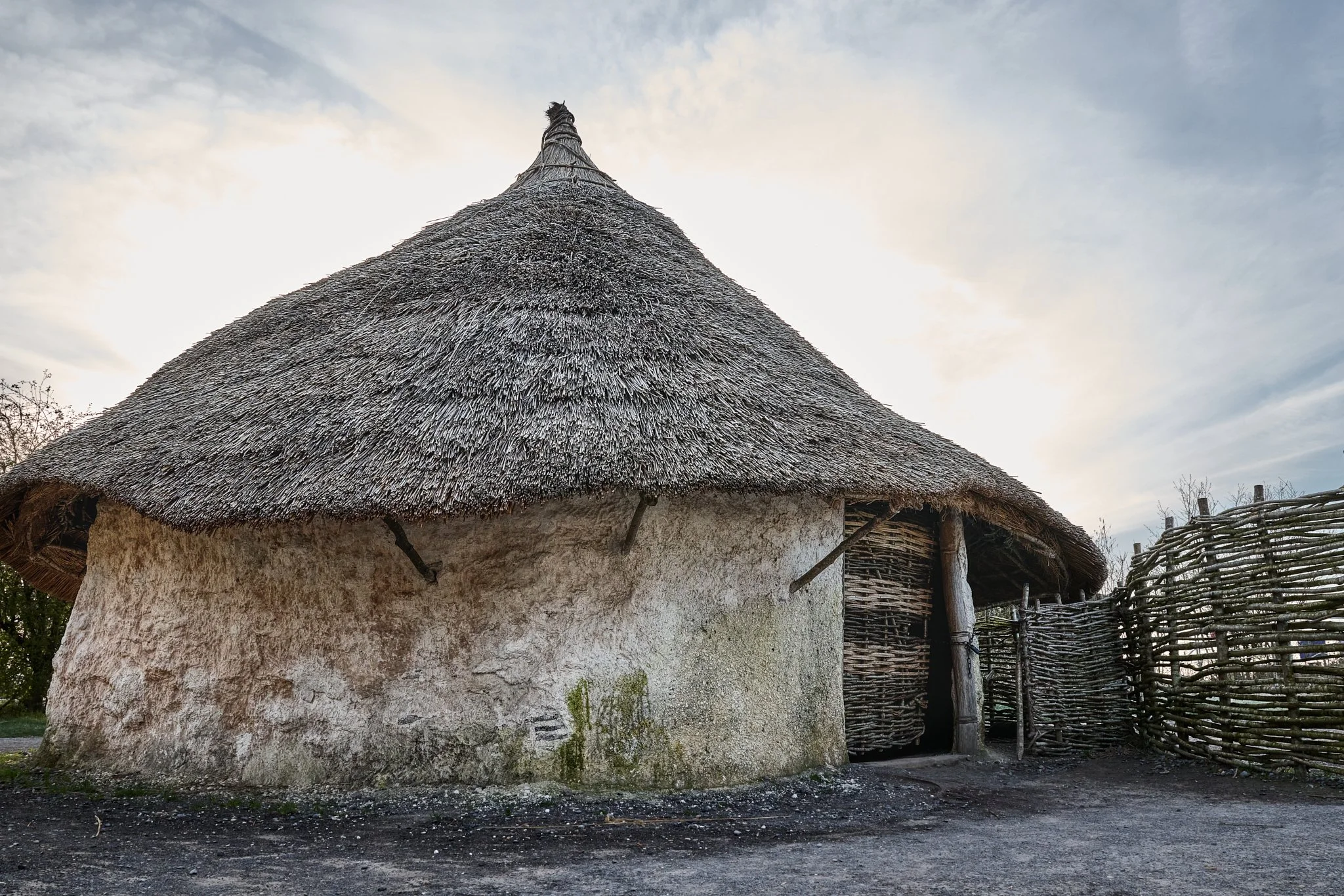 Documentary fieldwork photograph of a Neolithic Home in the Stonehenge Museum, showing the thatched roof and wattle-and-daub walls