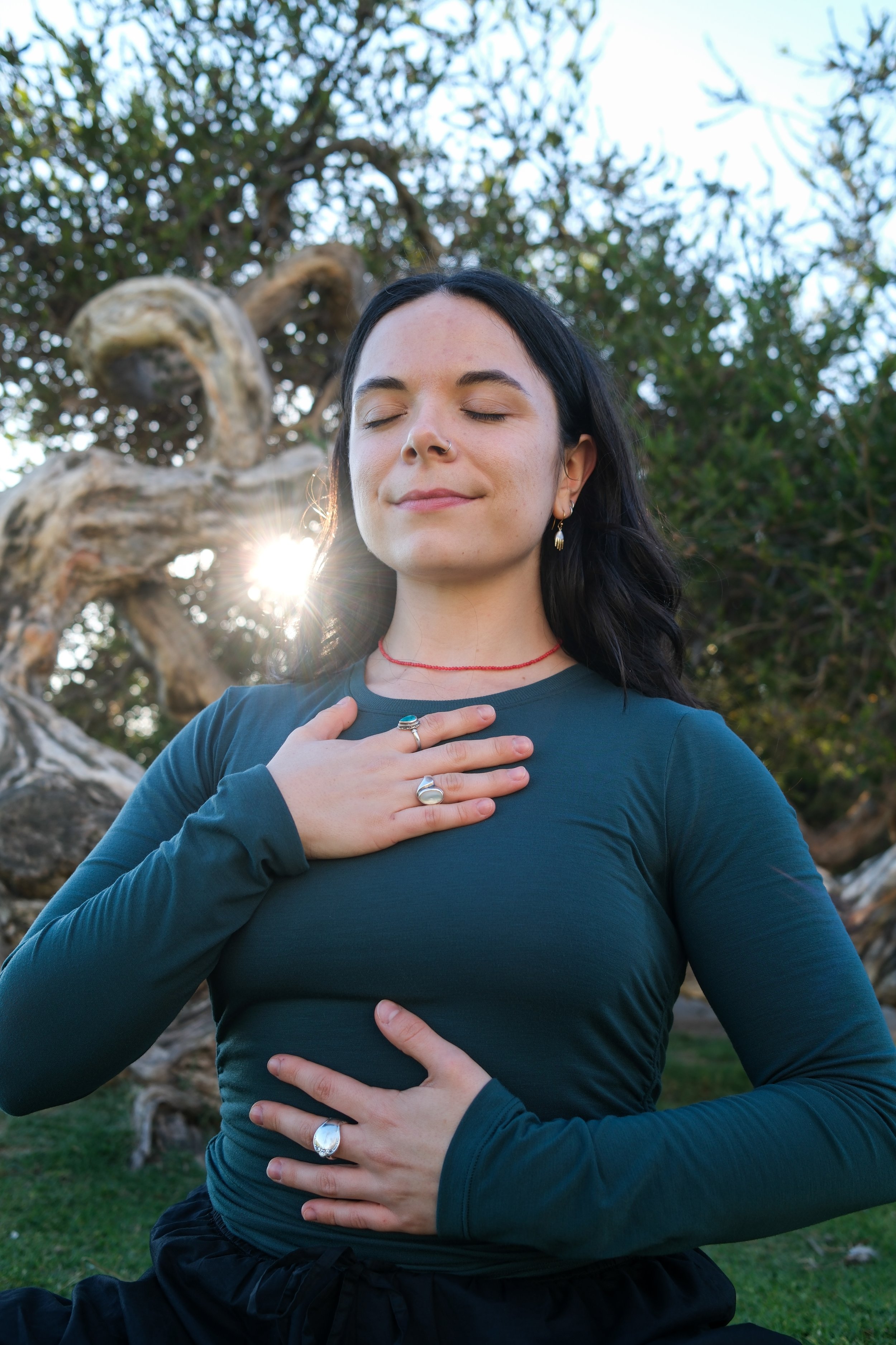 Gabby with one hand on heart and belly