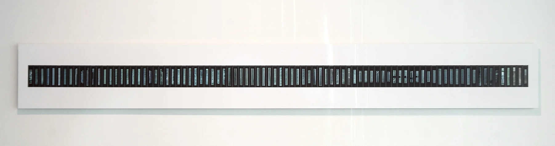 Peggy Weil, 2017. 88 Cores, Photographic Print 104” X 13” This print includes the 88 ice core segments illustrated in the film. It served as a key: visitors could use it to match the projection of the ice on the wall to a specific depth within the Greenland Ice Core.
