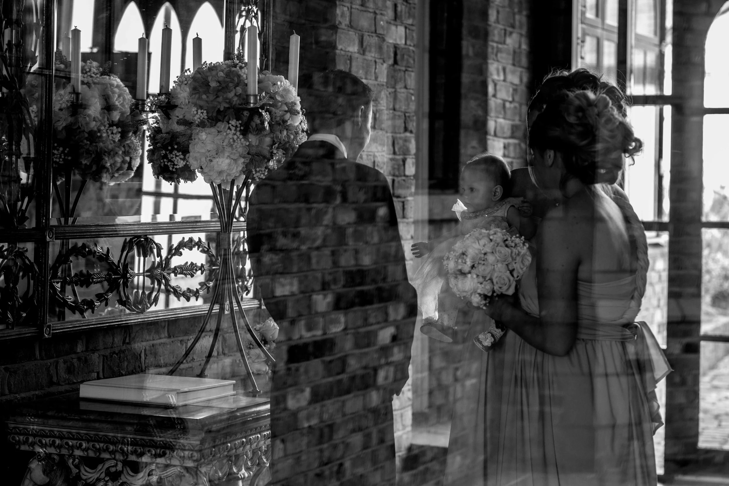 bridesmaids and groomsmen shelter inside from the wind before the bride arrives for her crabwall manor wedding