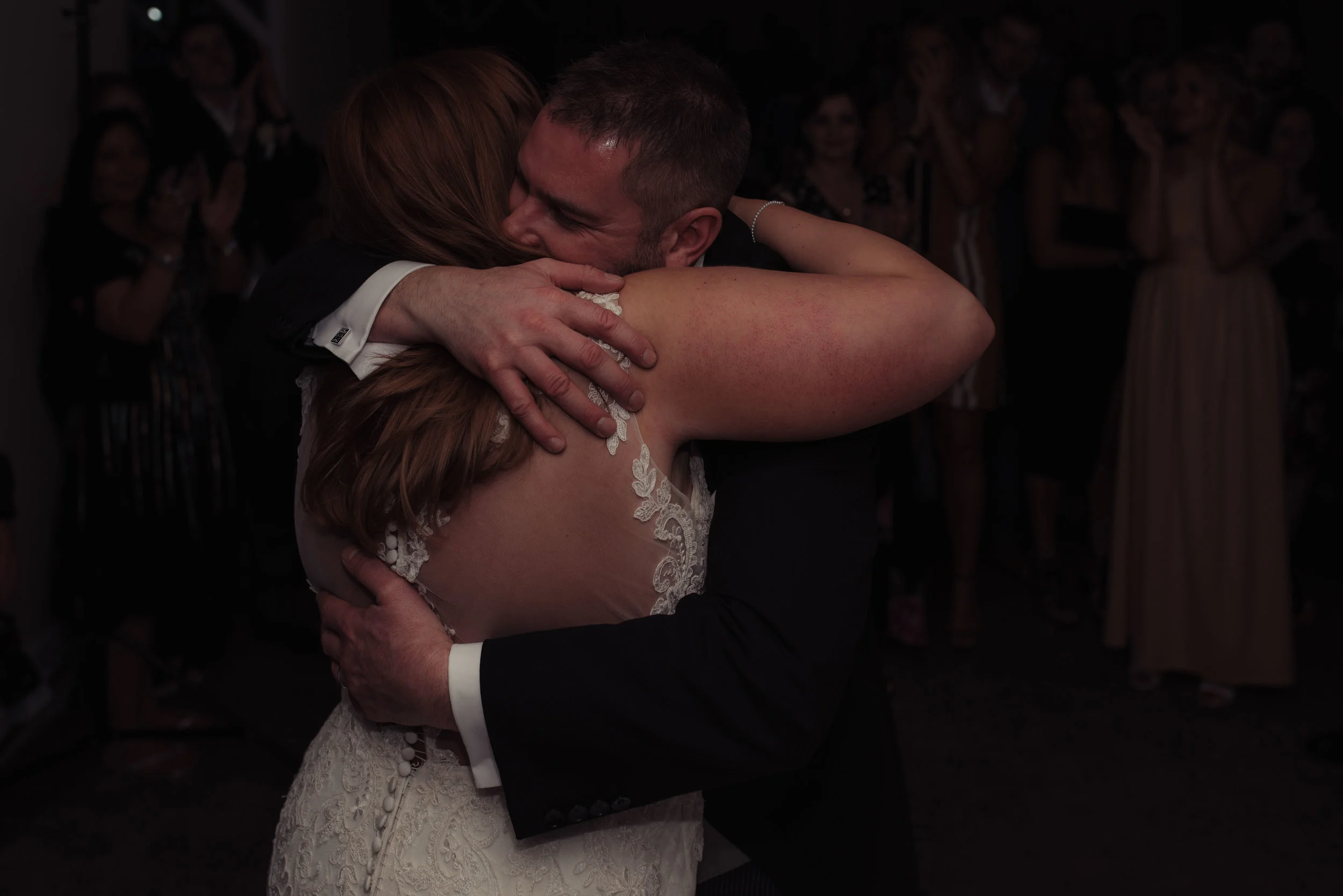 the brides father embraces his daughter during a dance after the first dance