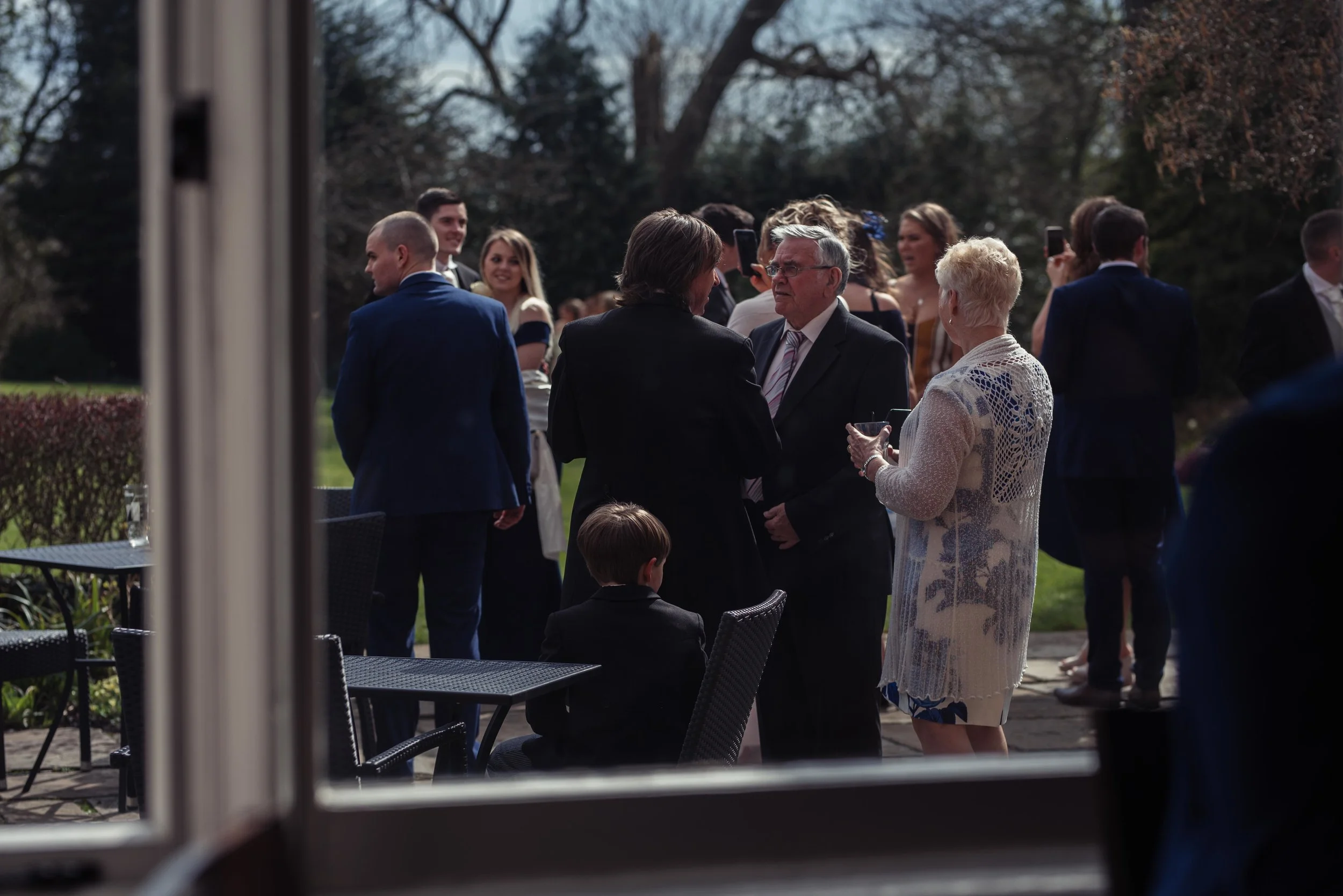 guests gather outside the venue for their cumbria wedding photography
