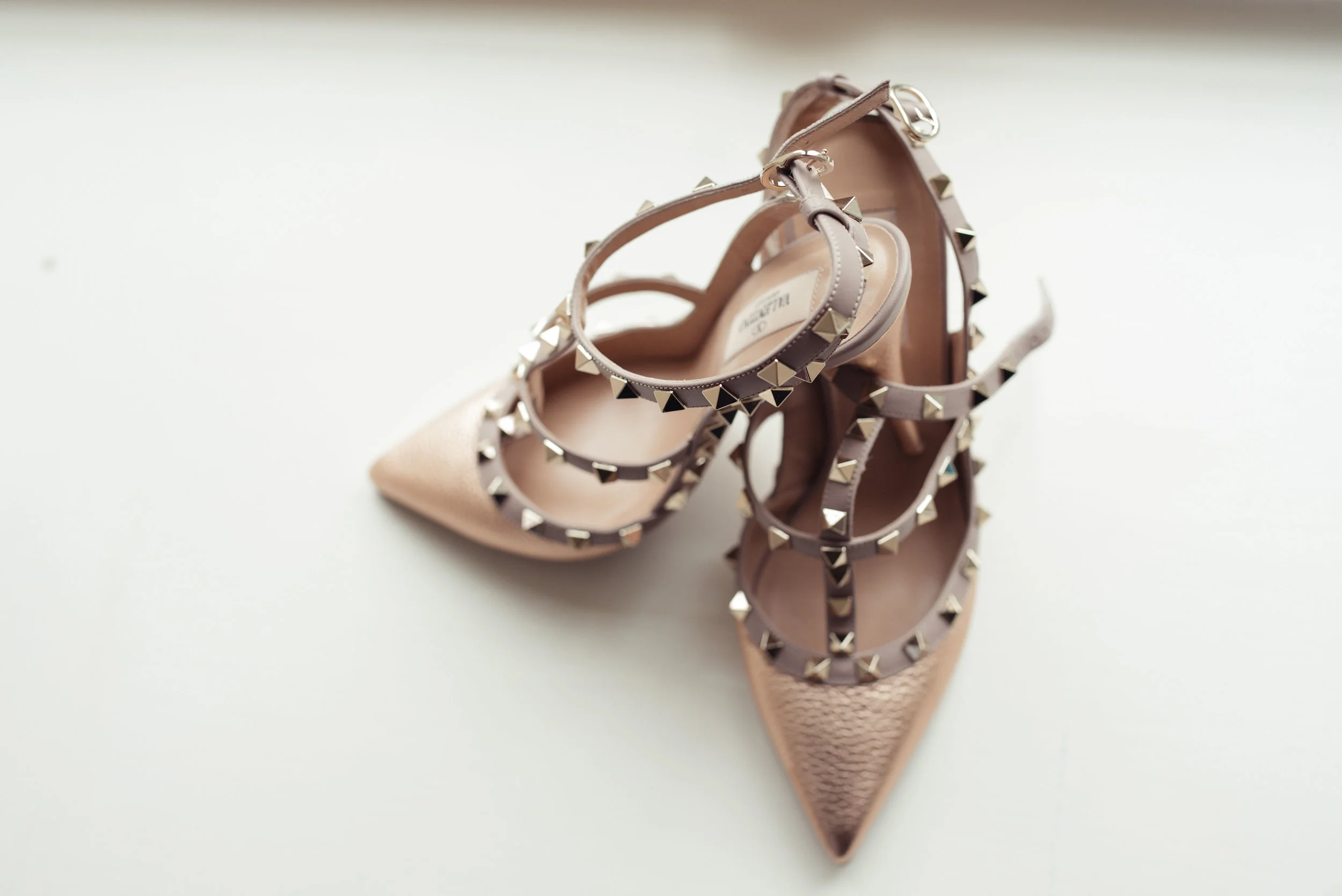 the brides shoes lit up by the daylight coming through the window