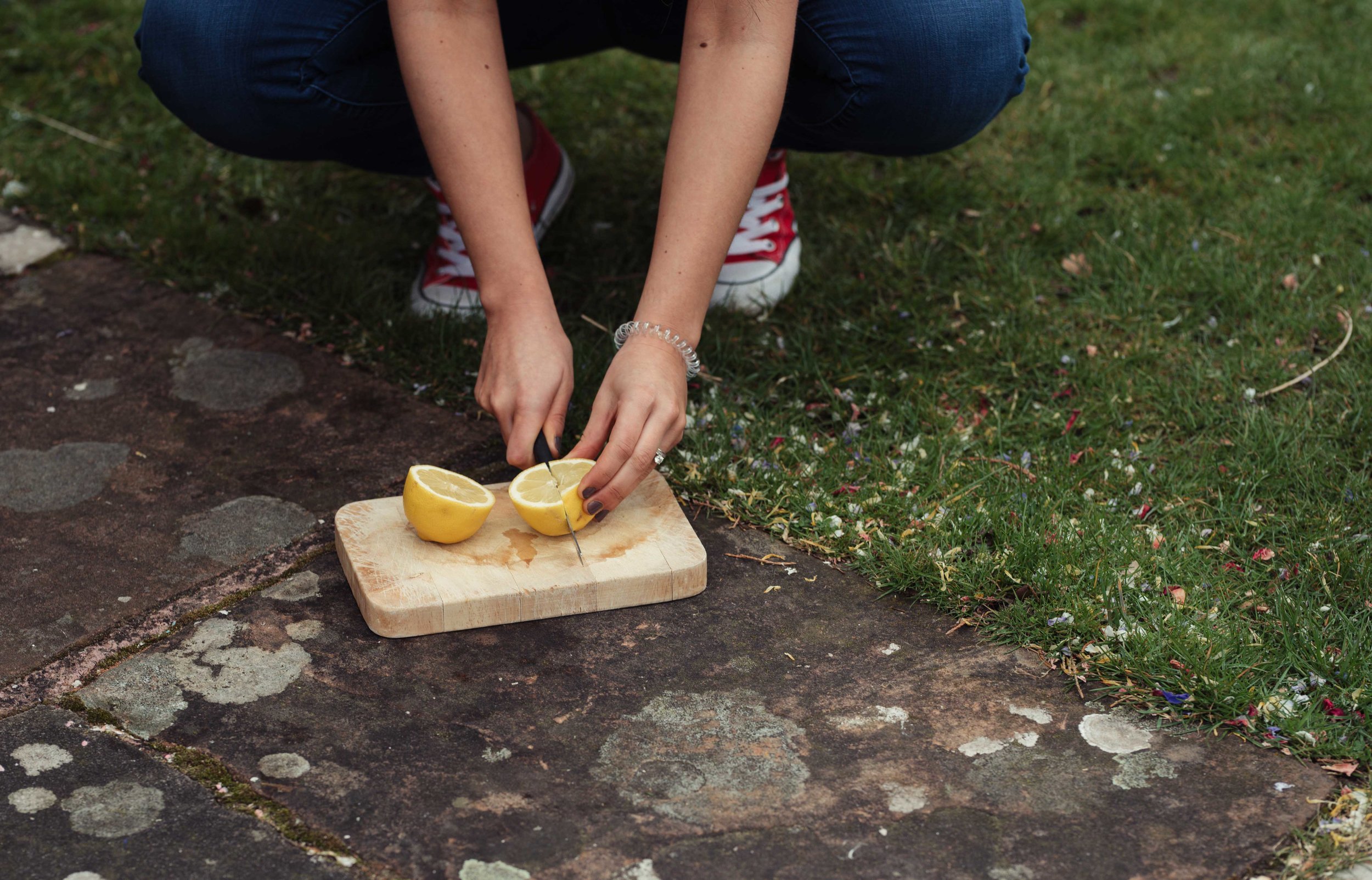 a bridesmaid cuts up lemons on the floor ready for the morning games