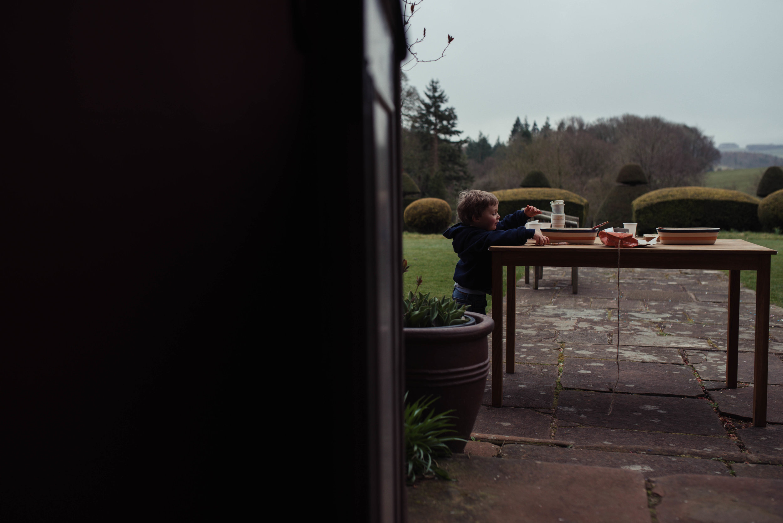 a young boy wedding guest plays outside Ashkam Hall before the wedding starts