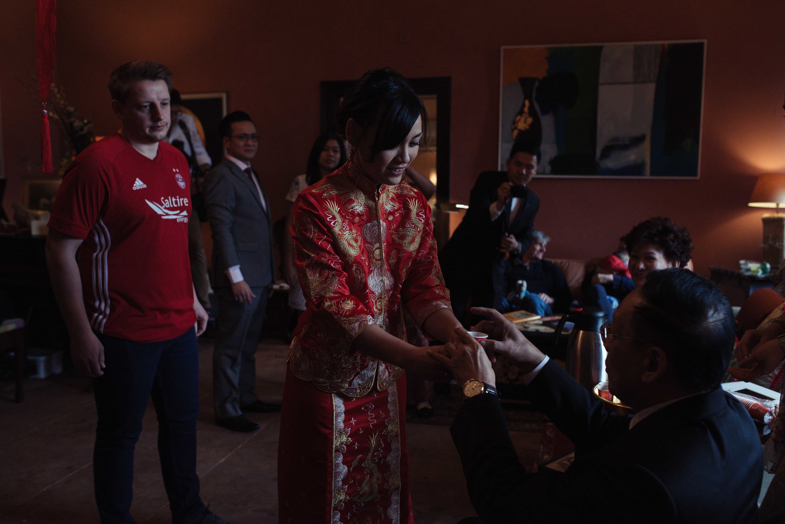 the bride serves tea to a member of the wedding party