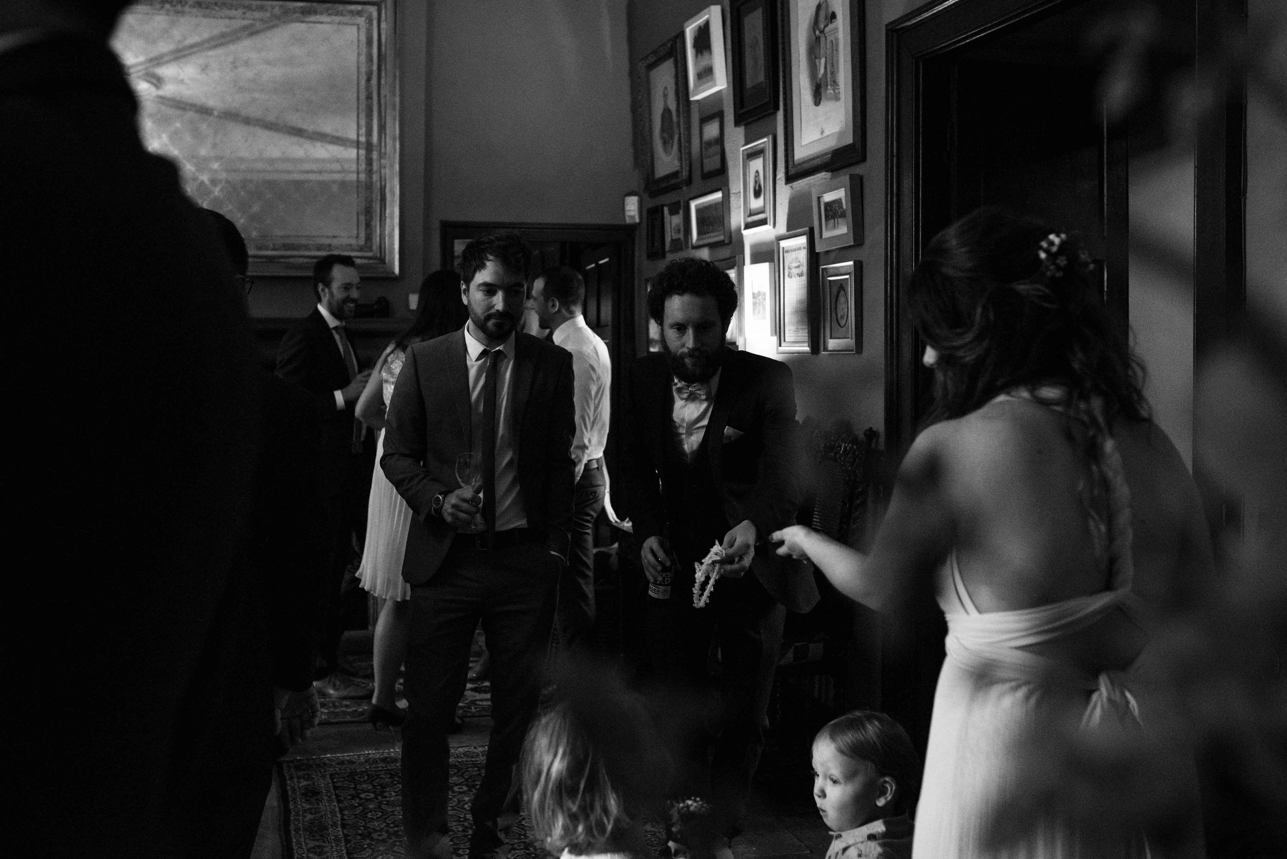 Wedding guests gather for their welcome drinks in the lounge of Askham Hall