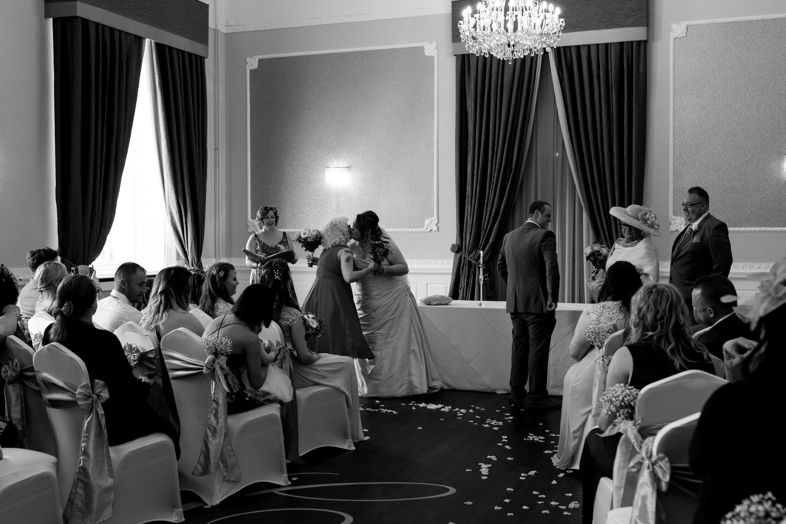 The bride and groom gift their mothers flowers during the wedding ceremony