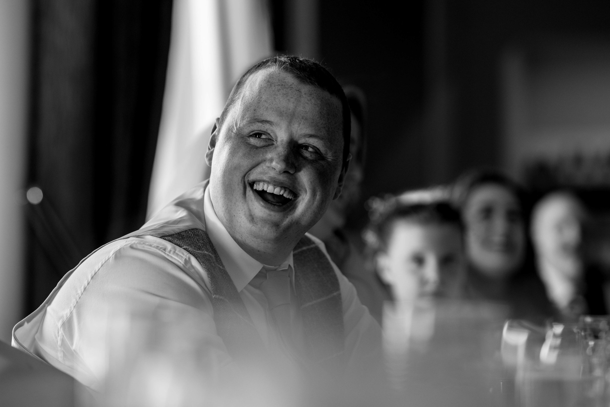 The groom laughs his head off at the best mans speech